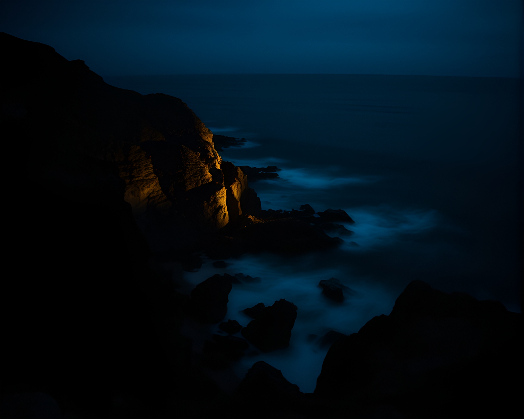 Chiaroscuro Rocky Coastline with Light Streaks – free AI stock image