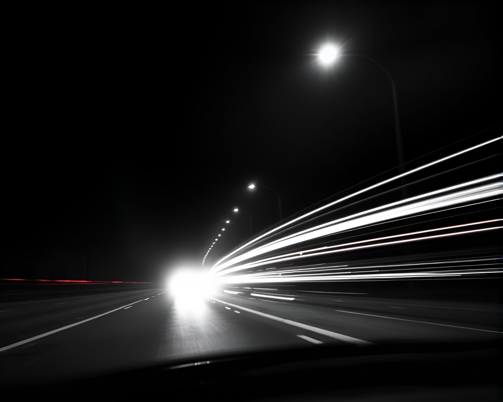 Desaturated gloom scene with car light trails and cat
