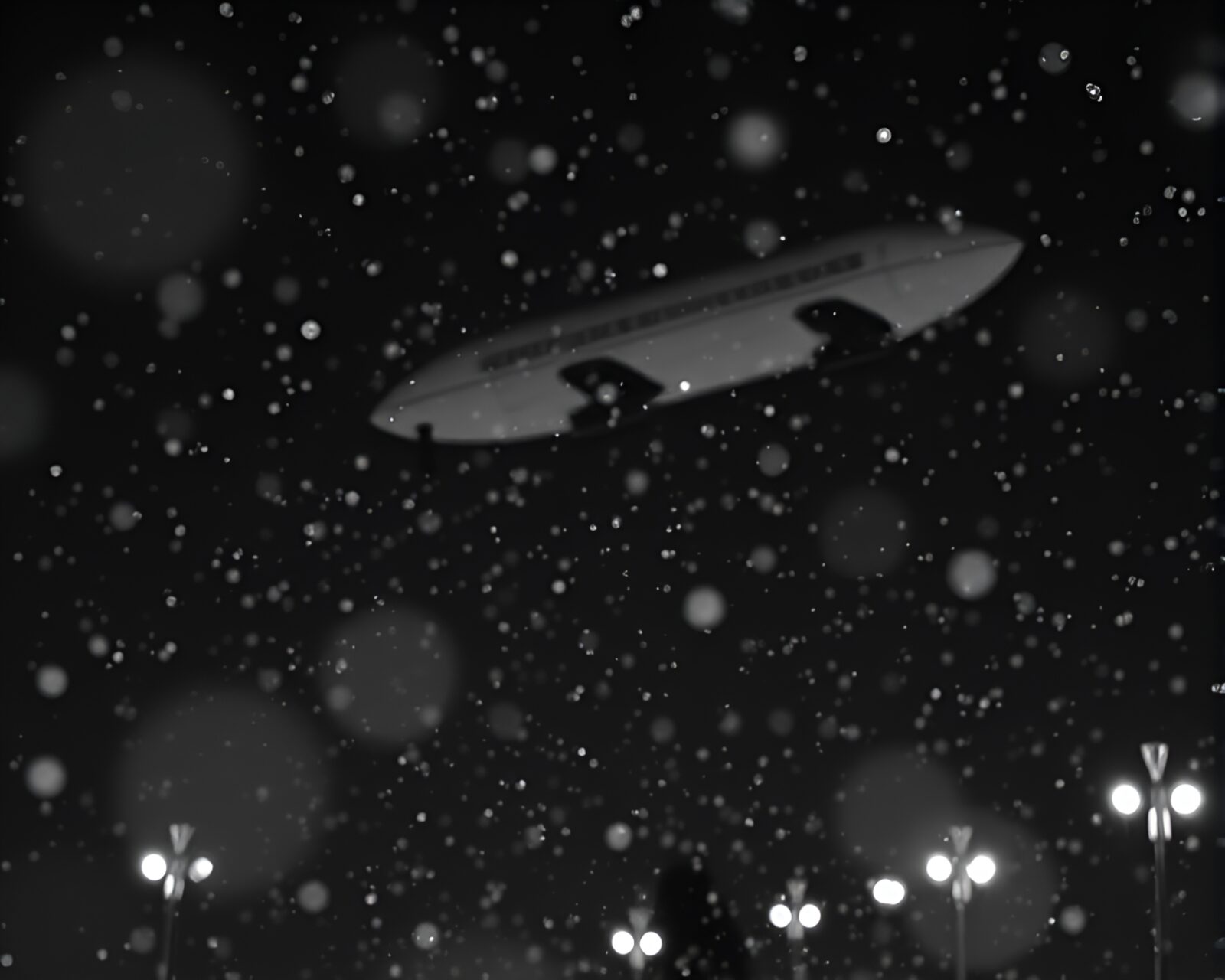 A majestic zeppelin floating under snowflake spotlight