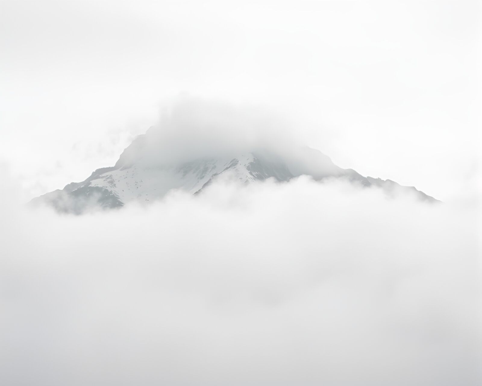 High-contrast image of a mystical mountain in mist