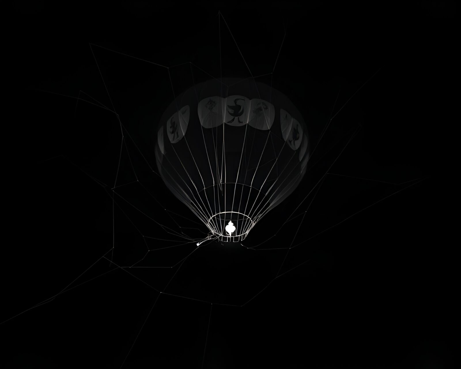 Spooky x-ray style image of hot air balloon in cobweb strands