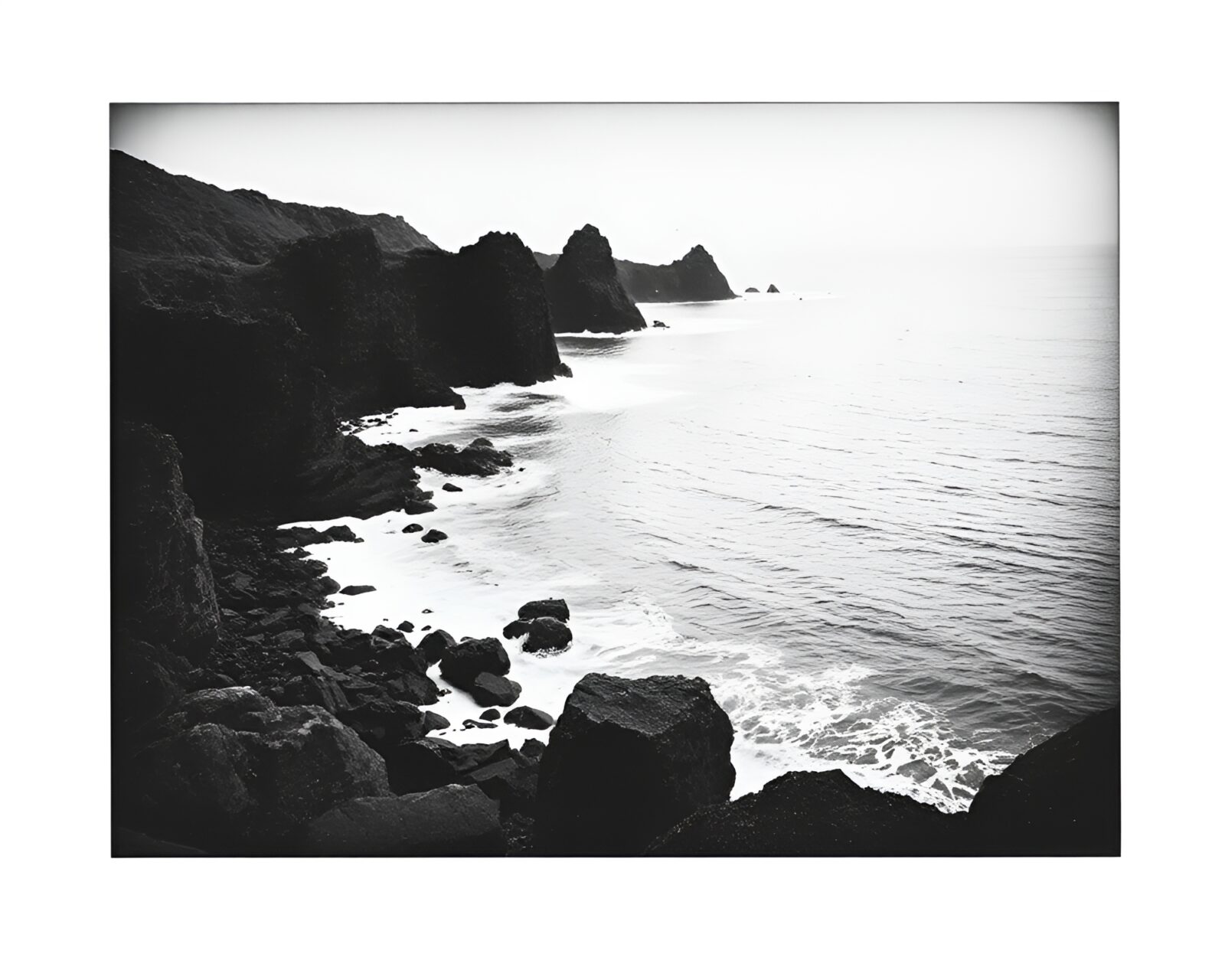 High-contrast Polaroid-style image of etched rocky coastline