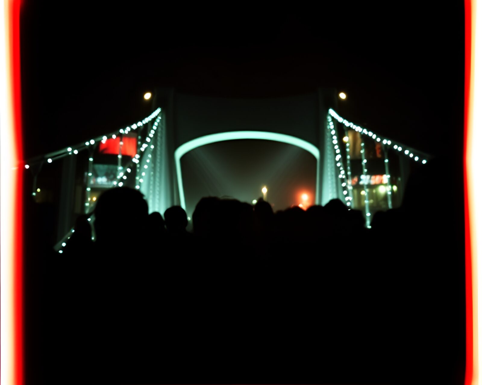 Candid scene on glass bridge with club strobe lights