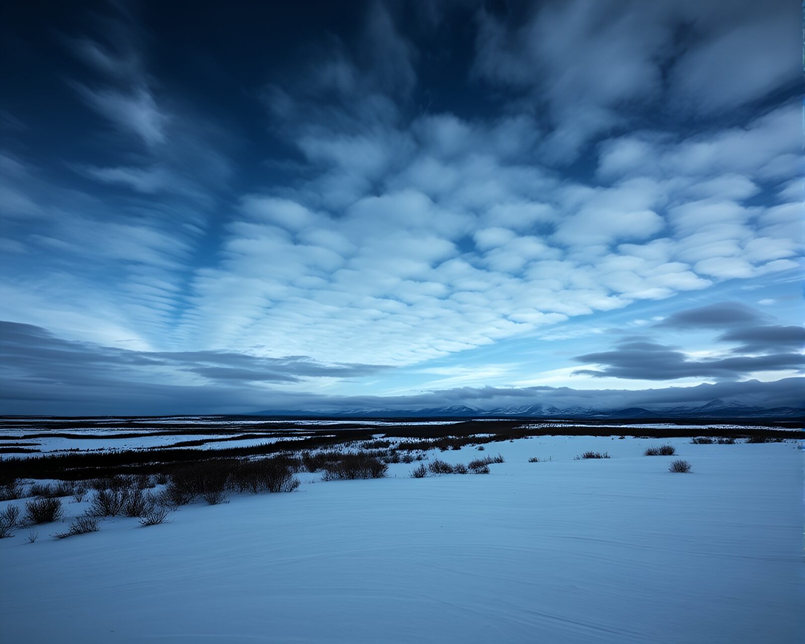Majestic northern lights shimmering over icy tundra landscape