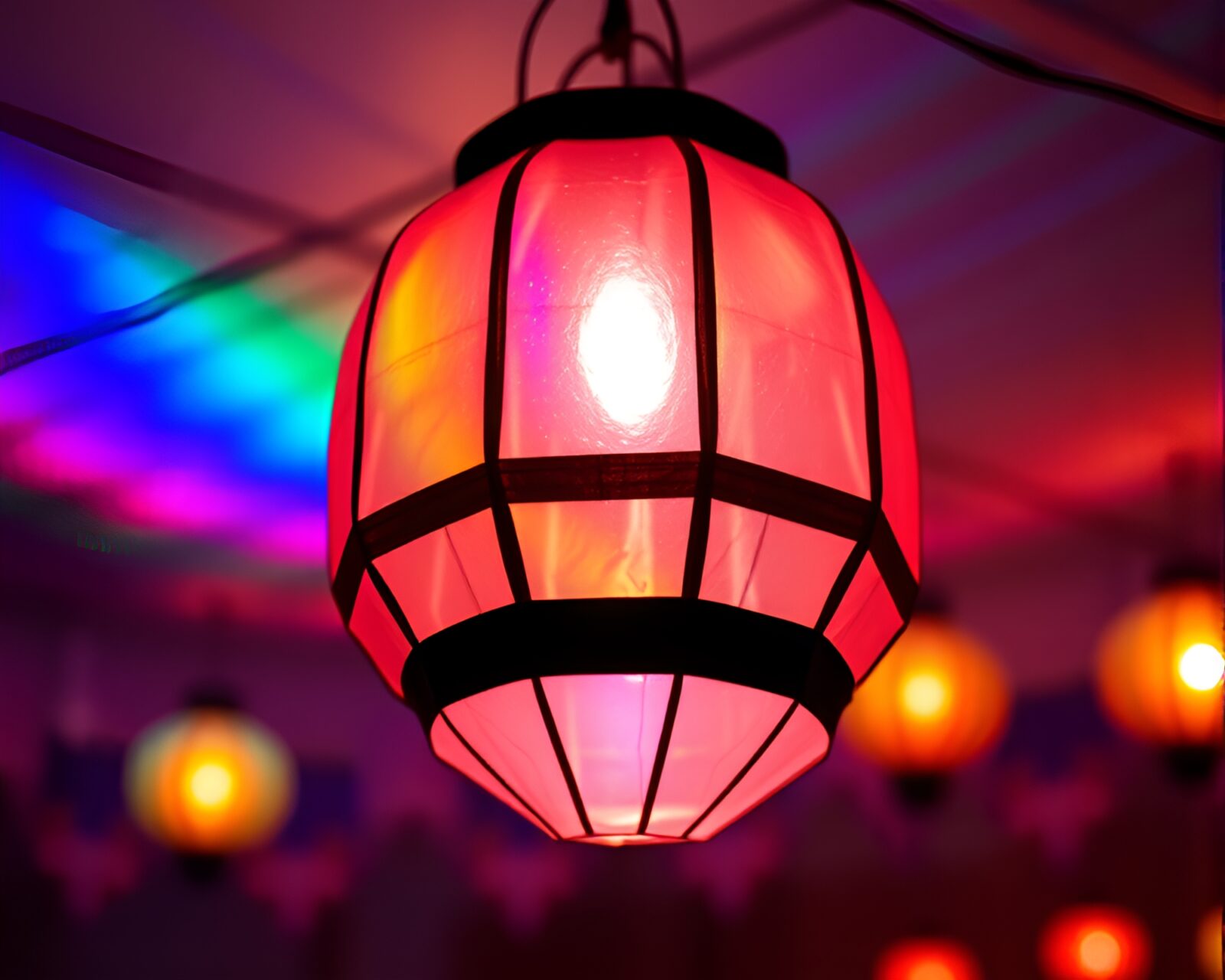 Vibrant rainbow colors shining through ornate sapphire paper lantern