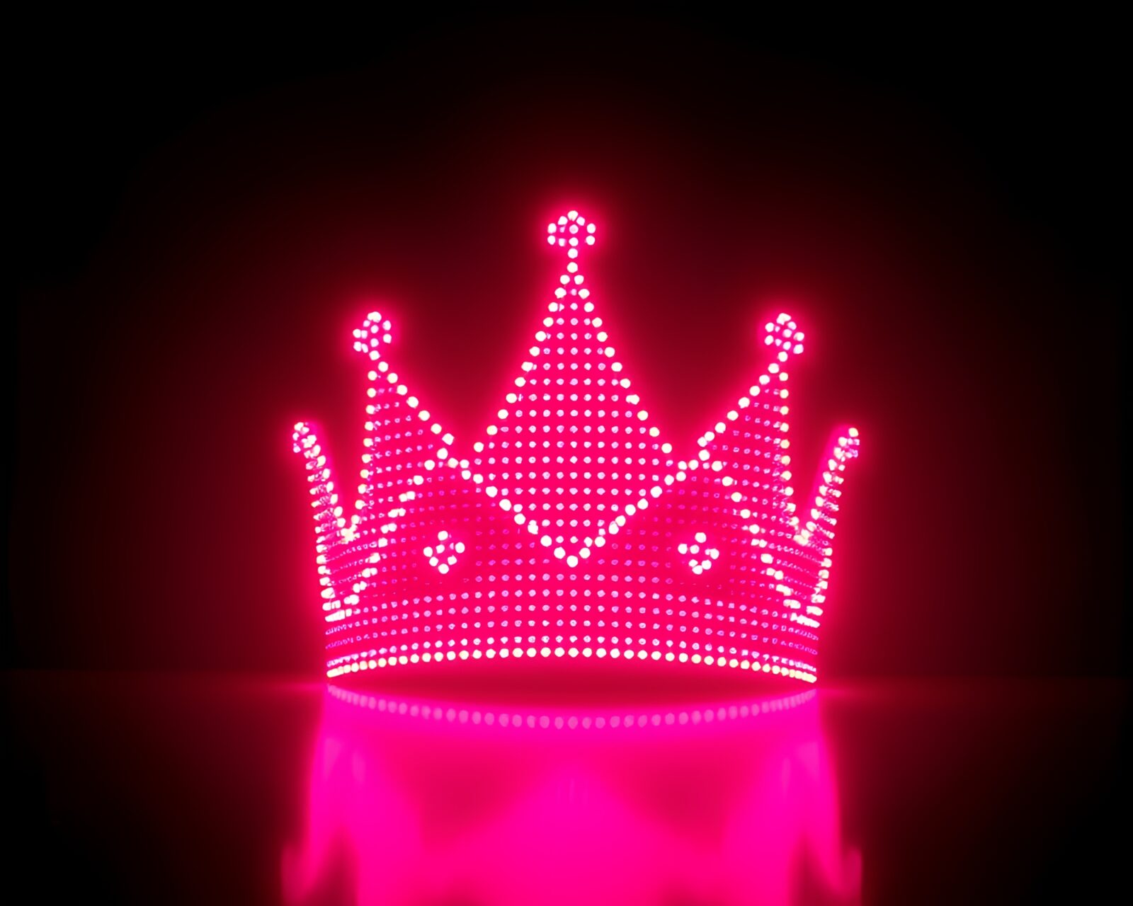 LED pixel grid forming a majestic crown illuminated in sunrise-pink light
