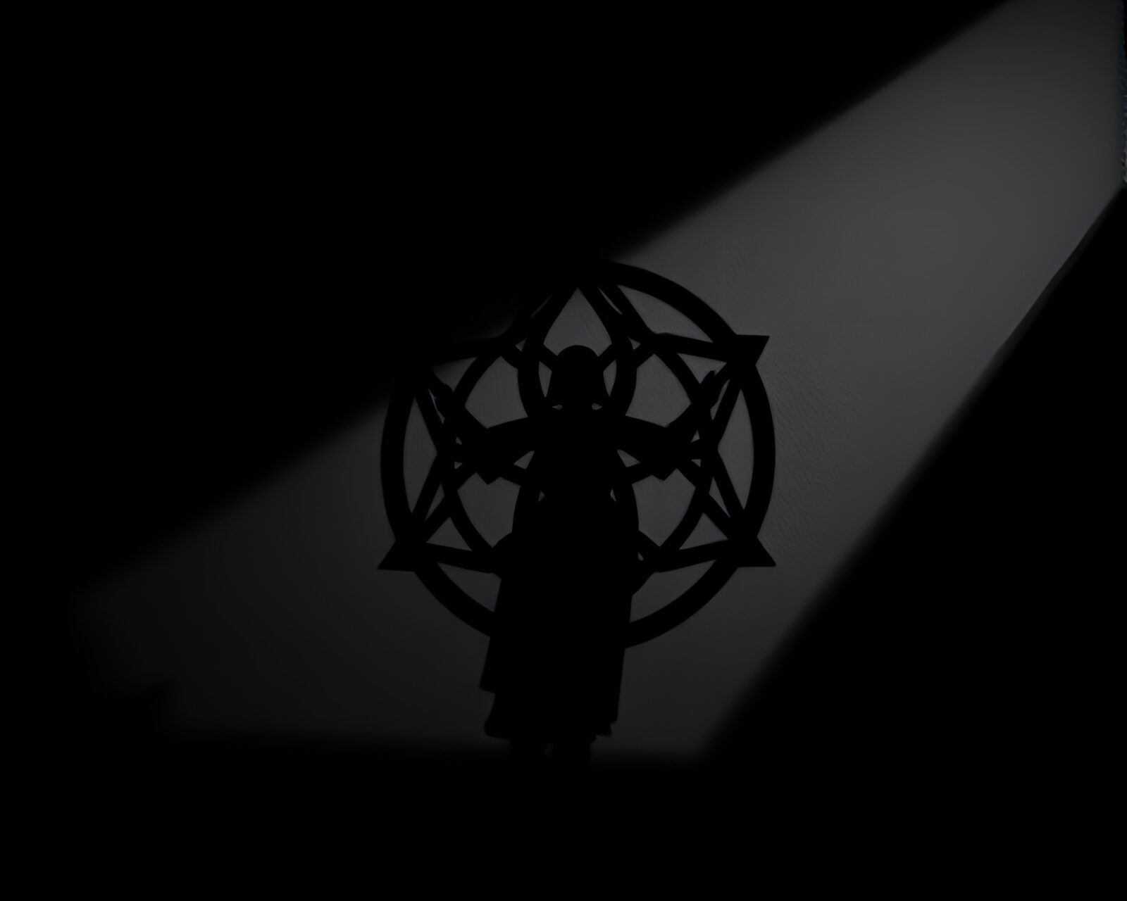 Mysterious silhouette in shadow with sacred geometric patterns