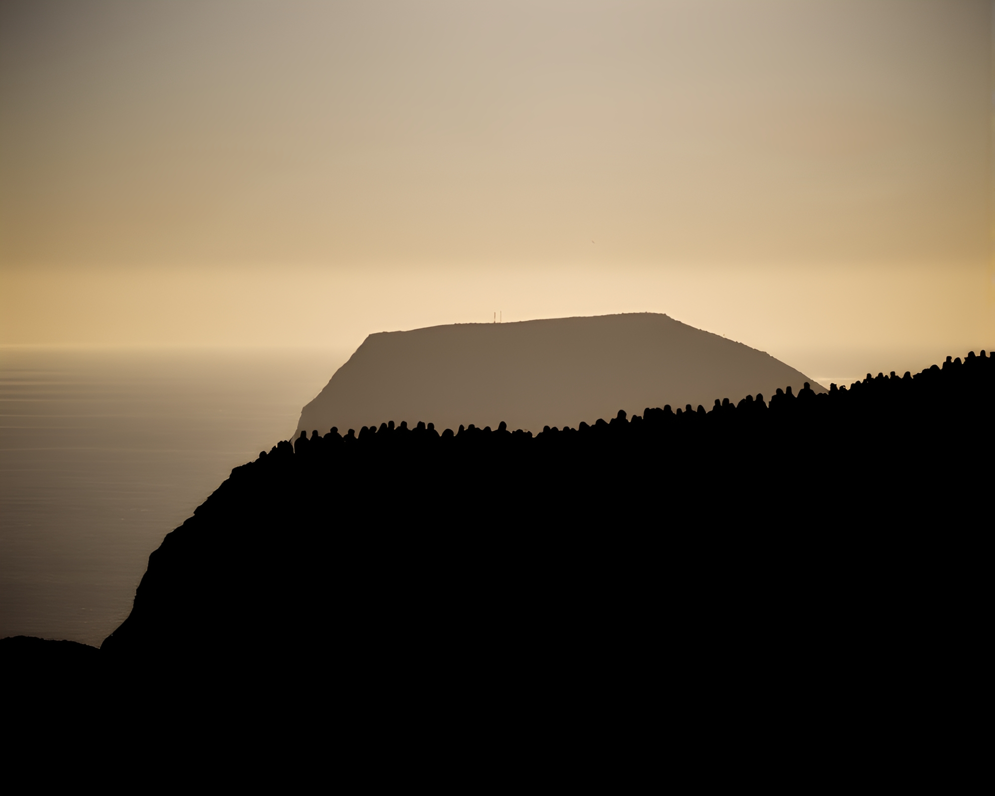 Shadowed Silhouettes on Island Cliffside – free AI stock image