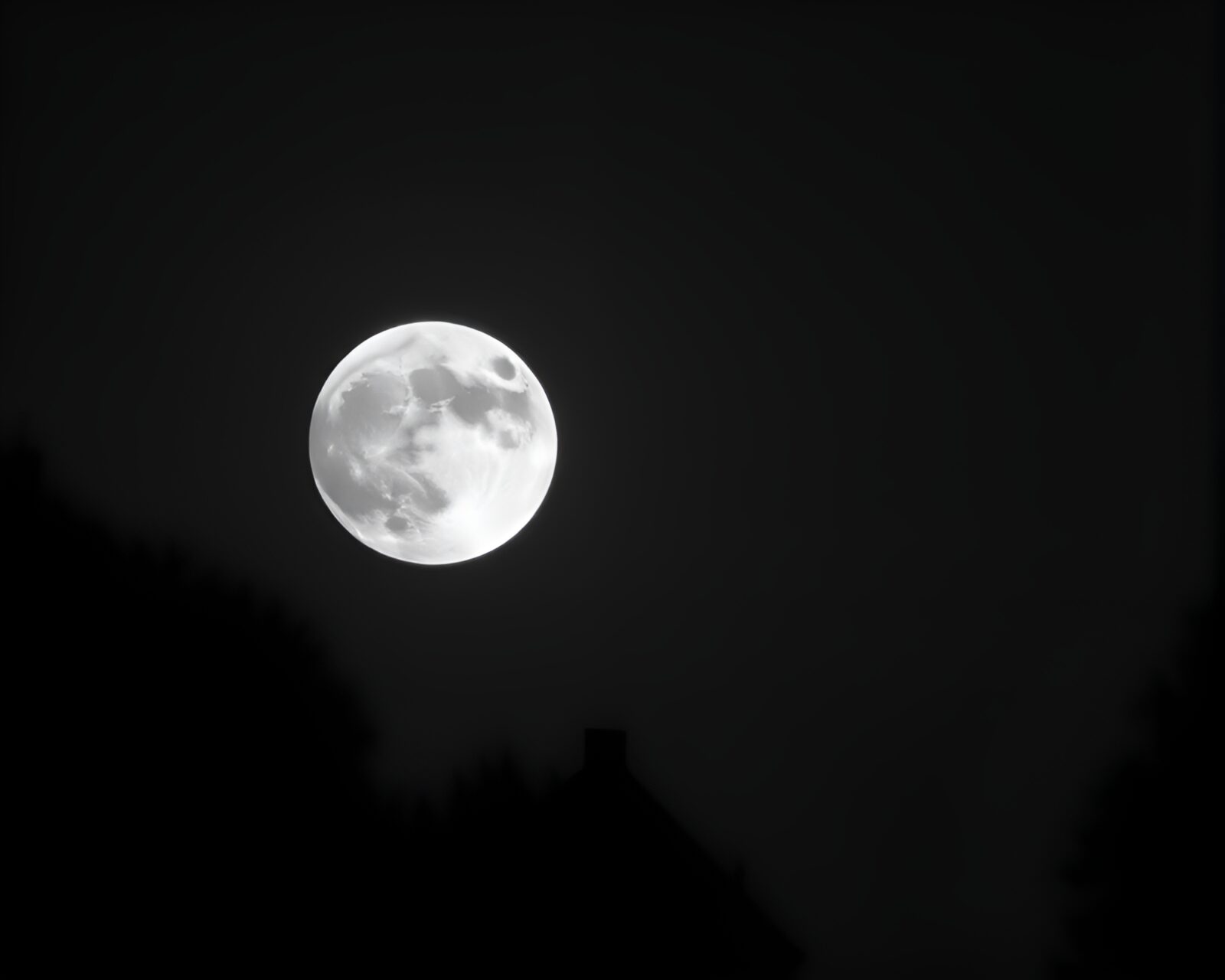 Backlit crystal floating in moonlit silhouette against angled view