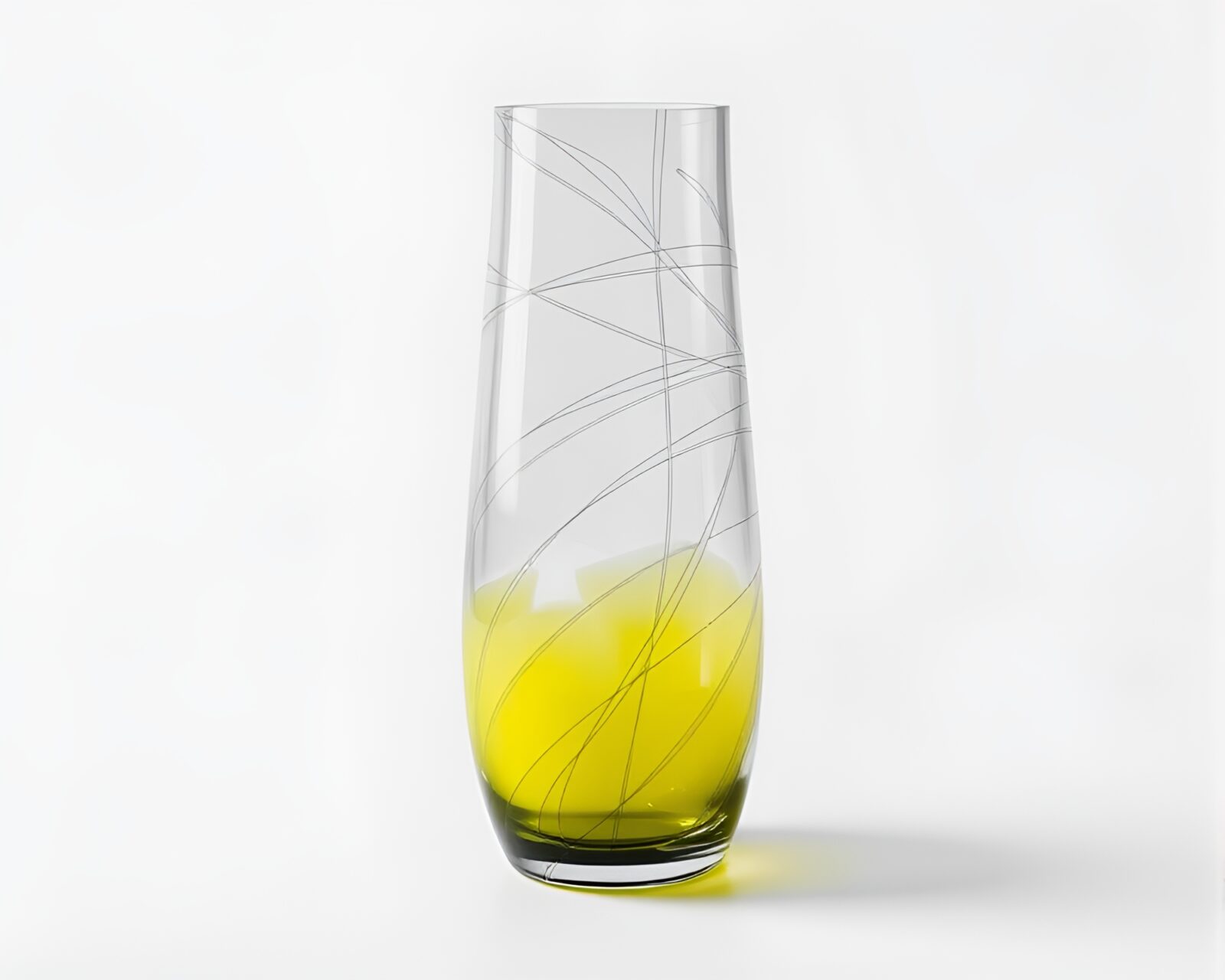 Lemon yellow vase with intricate etchings in dramatic lighting