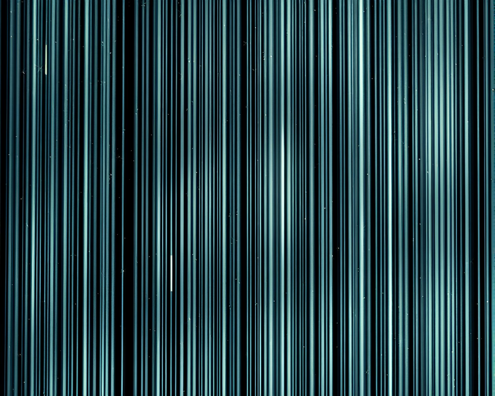 Glowing barcode stripe surrounded by shimmering stardust fractals