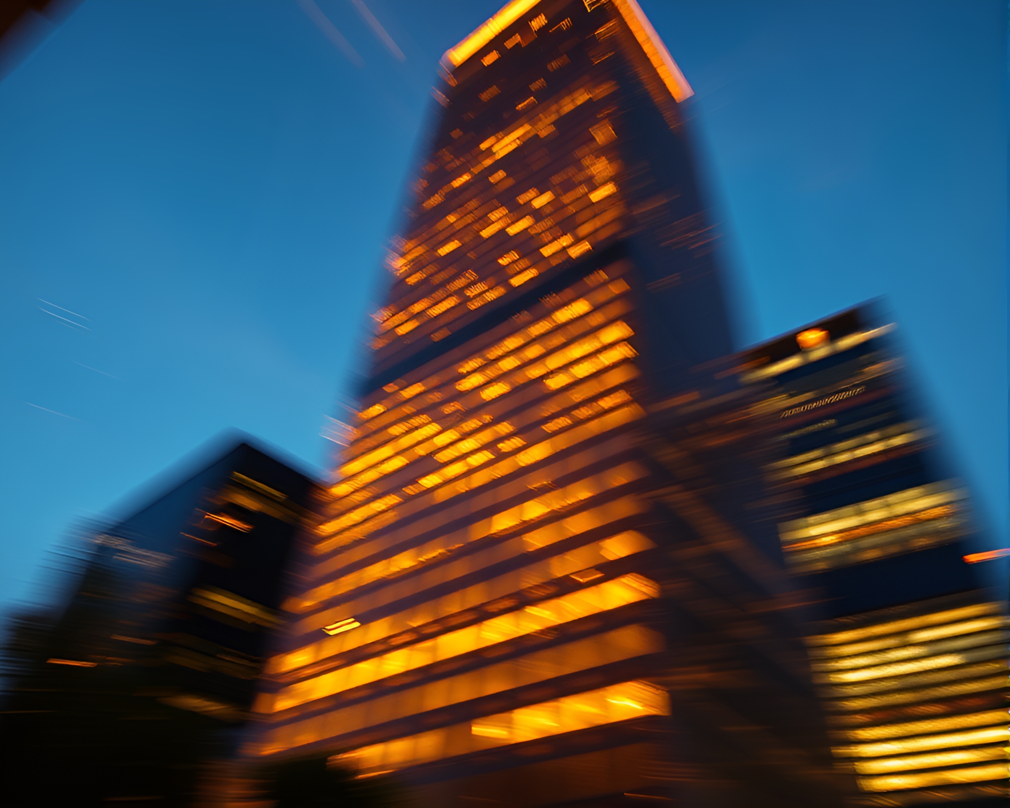 Urban Skyscraper Pan Motion Blur at Golden Hour – free AI stock image