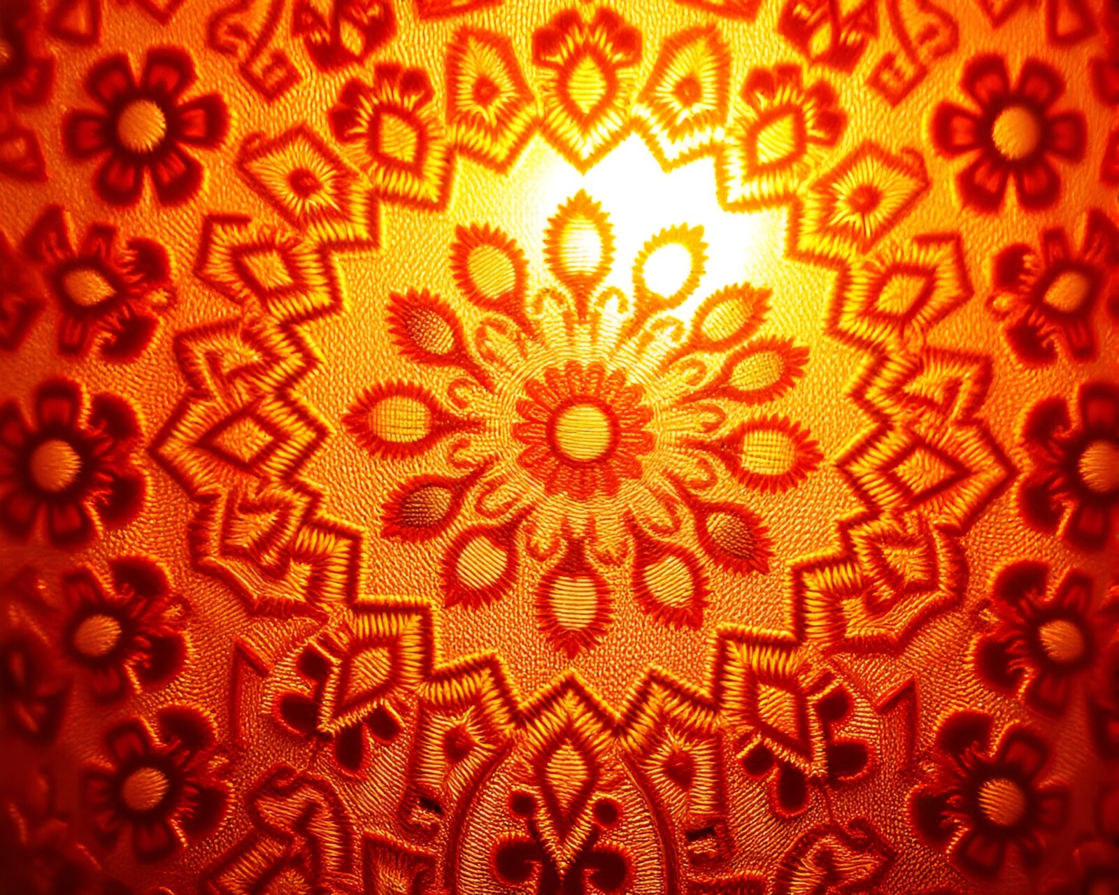 Intricate embroidered detail glows in afternoon warmth under tenebrist lighting