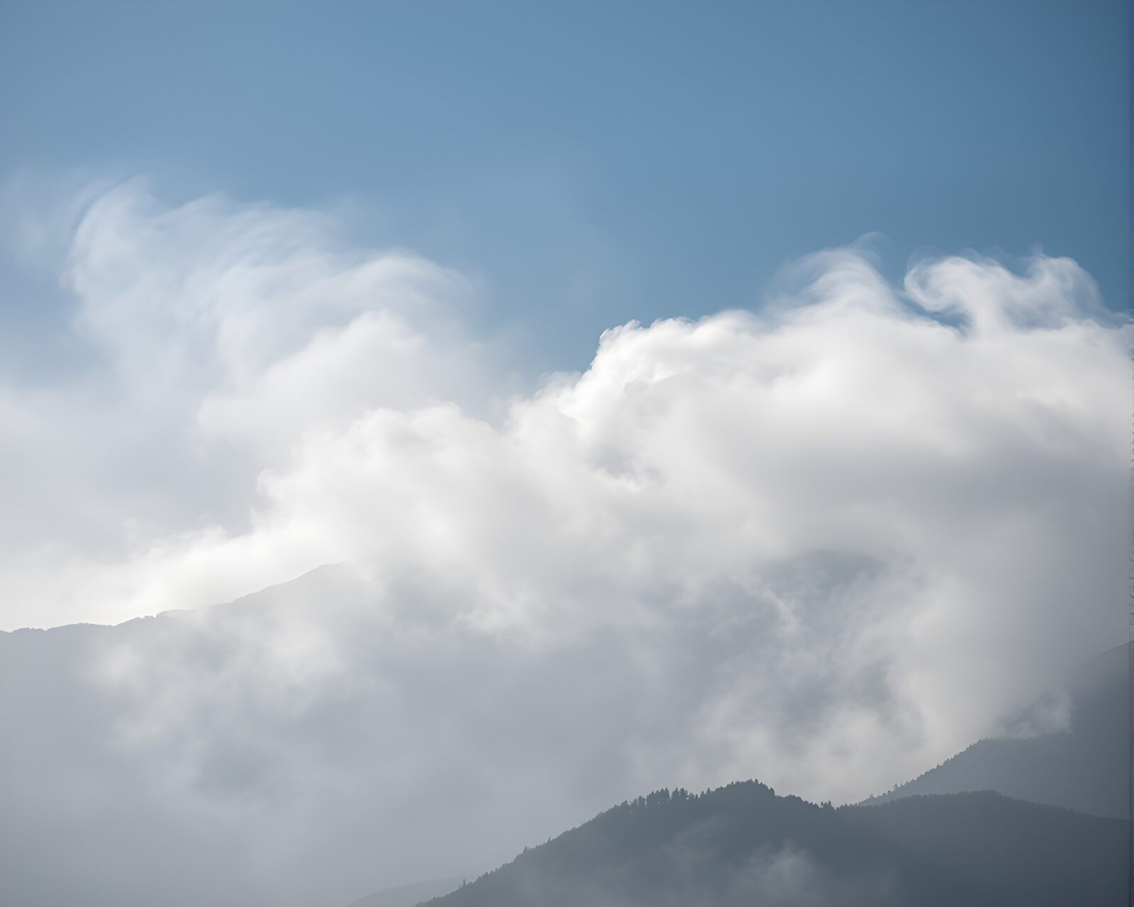HDR misty mountain scene with swirling smoke plume