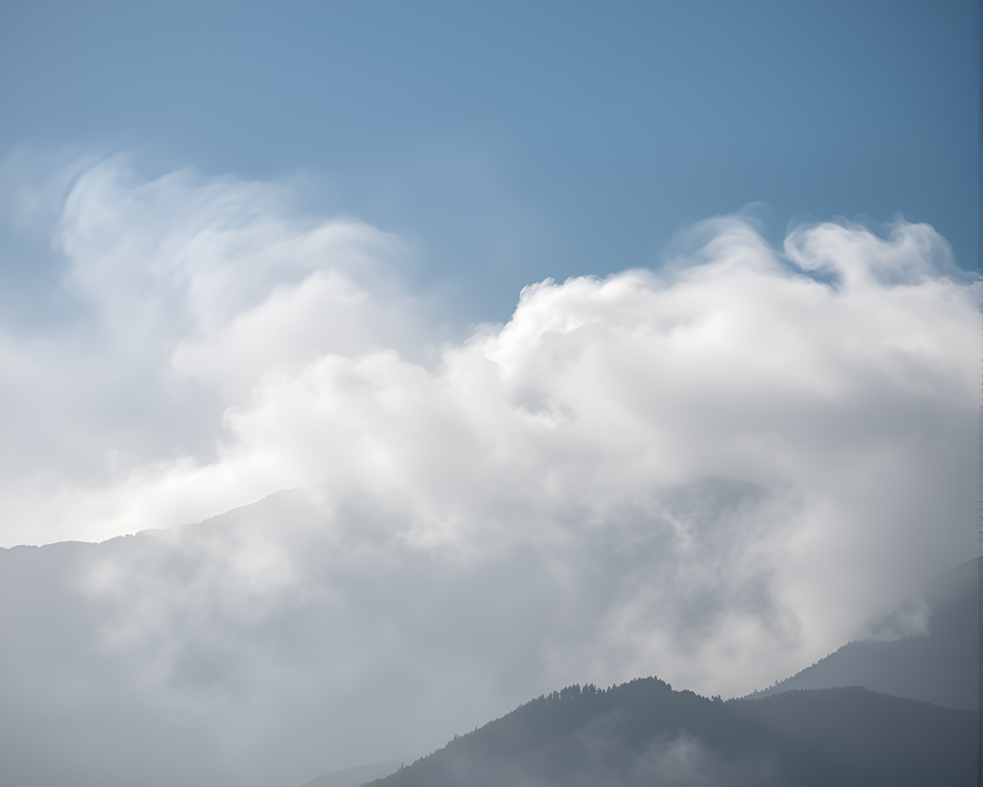 Mist-Shrouded Mountain with Swirling Smoke Plume – free AI stock image