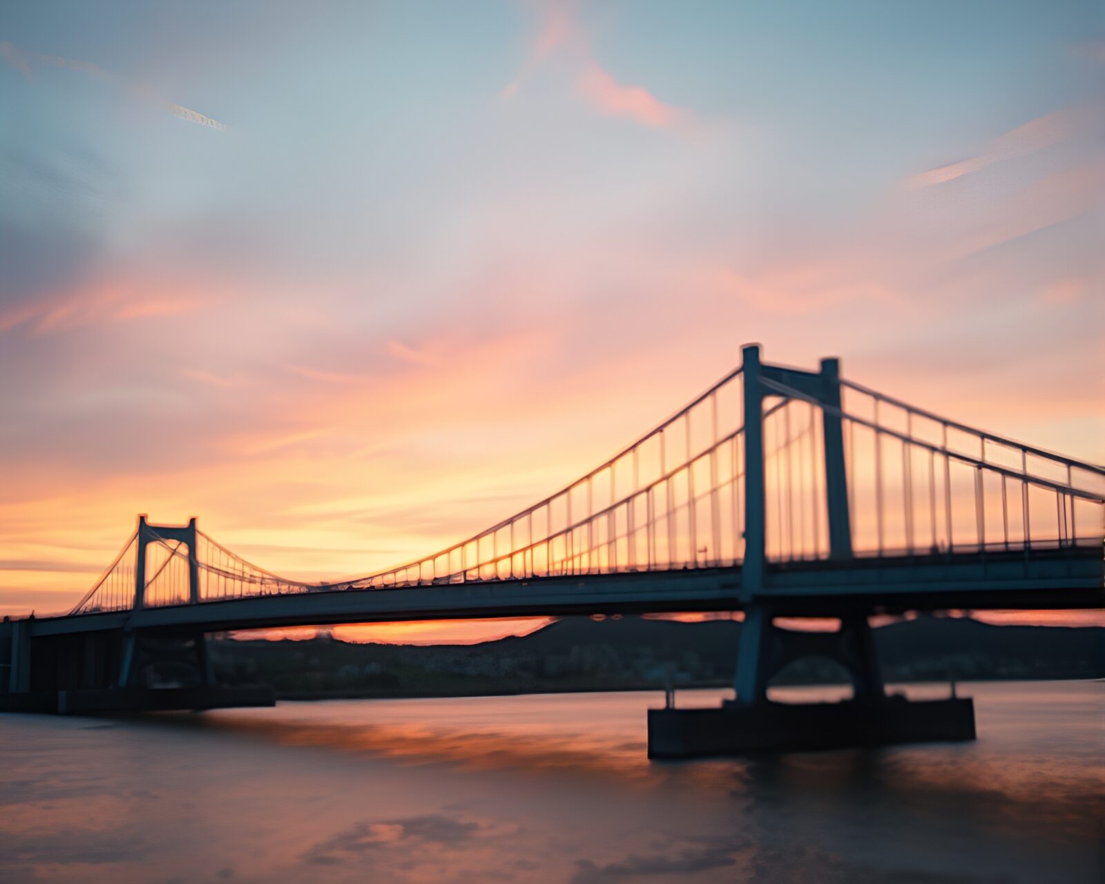 Sunrise colors through distorted lens on glass bridge
