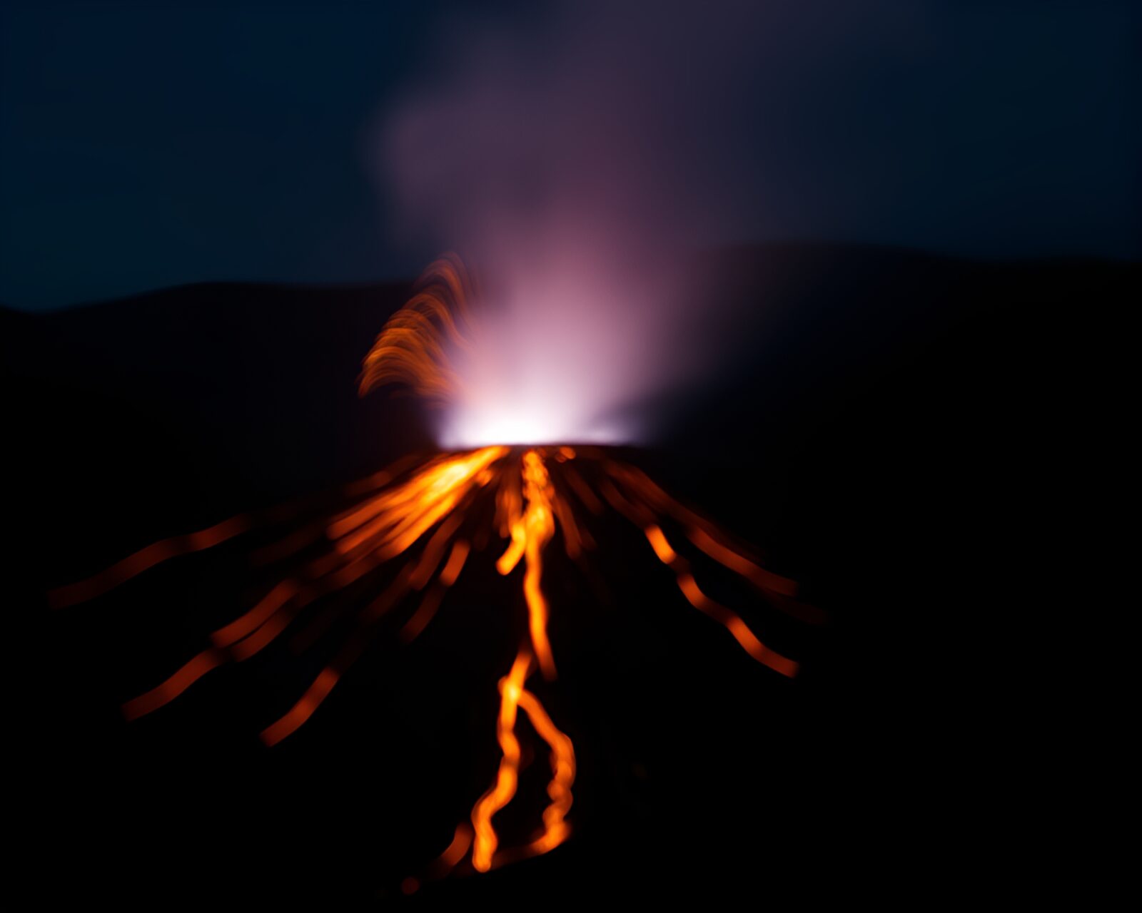 Glowing lava streaks in the dark with blurred background