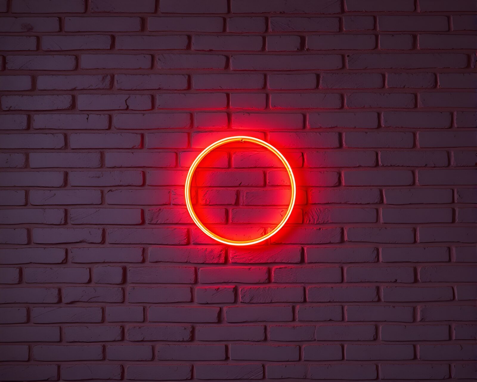 Bright neon sign shaped like baguette in urban setting
