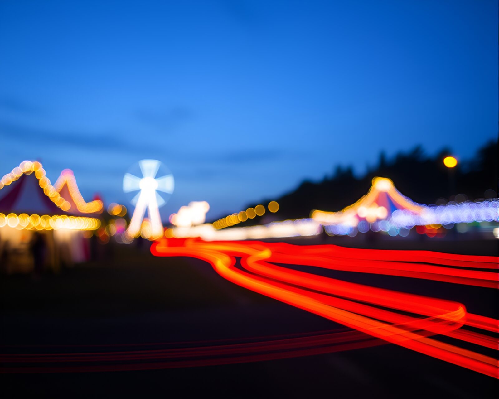 Colorful light trails in carnival atmosphere with shallow focus