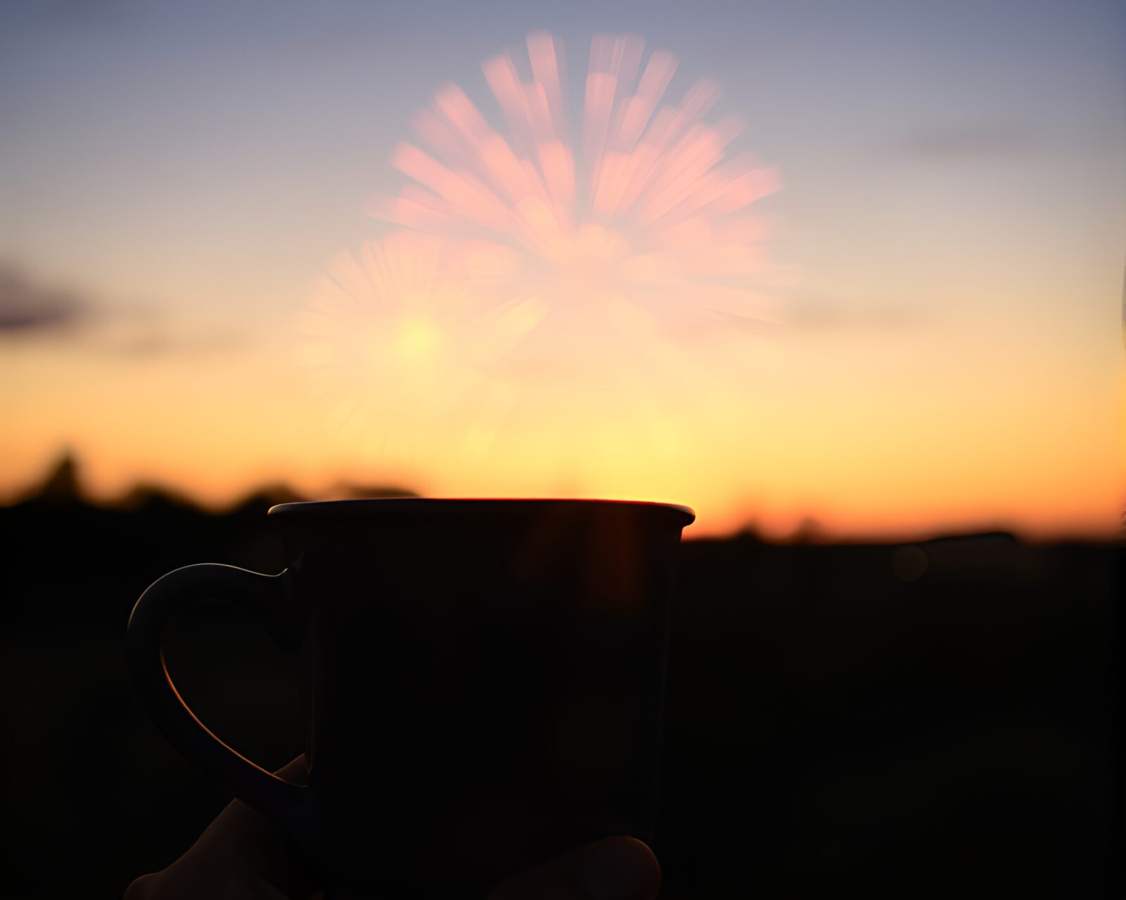 A mesmerizing image of coffee cup amid fireworks at dusk