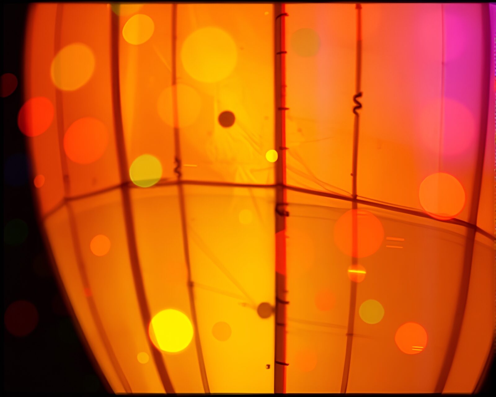 Abstract digital art of film sprocket holes entwined with paper lantern in glitch colors