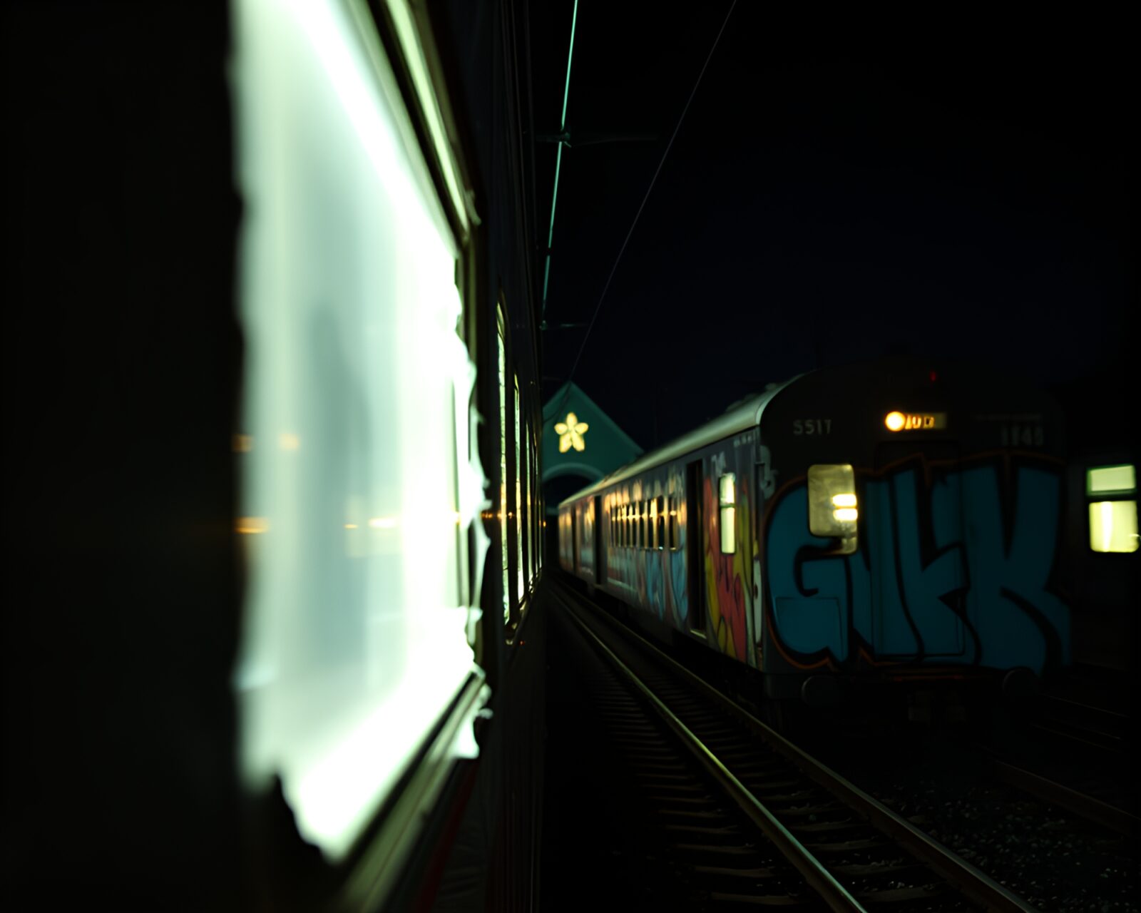 Abstract image of a train amid candlelight in graffiti-filled church
