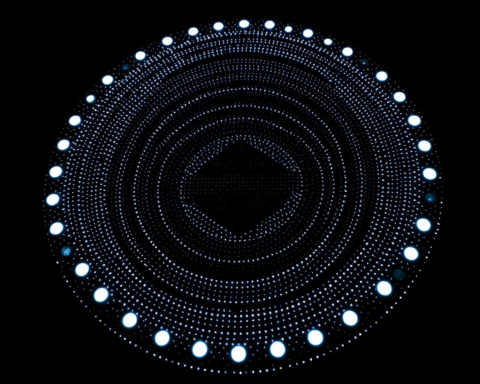 High-contrast noir scene with glowing stone circle and dot matrix design