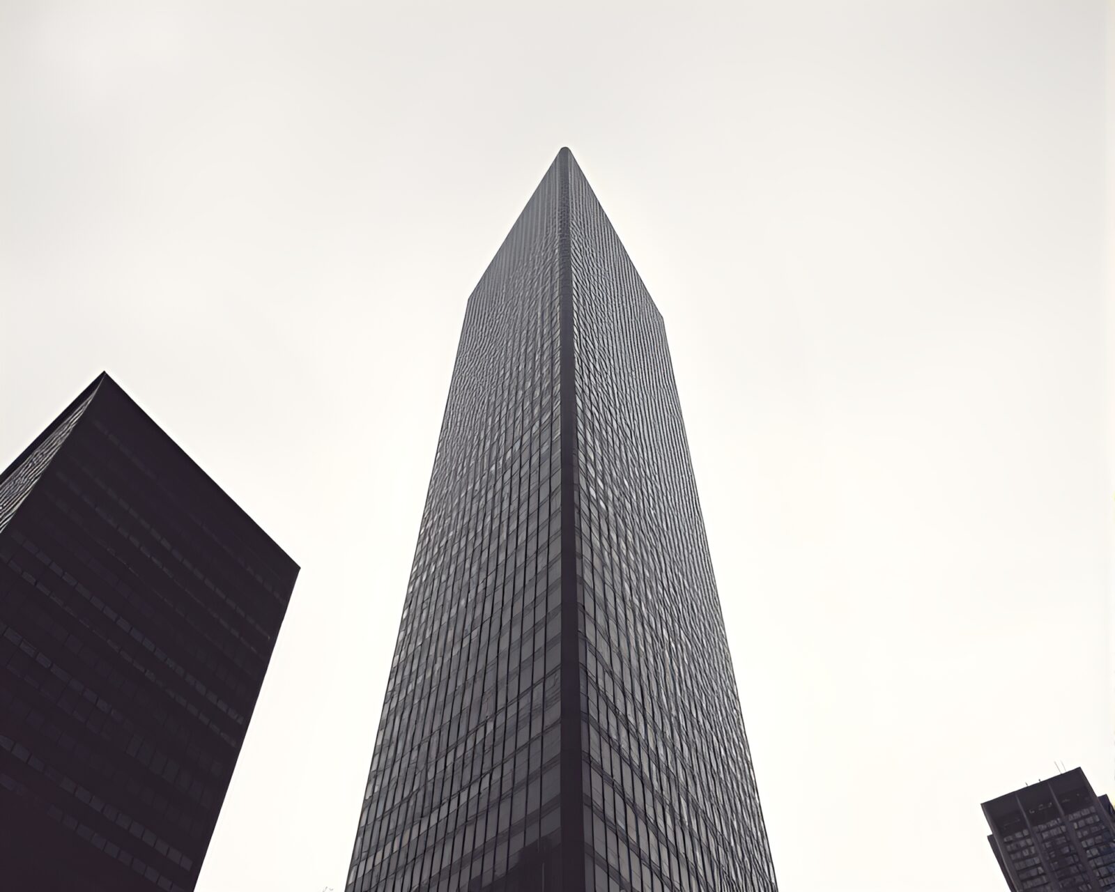 Off-center skyscraper in monochrome blue with sepia tones