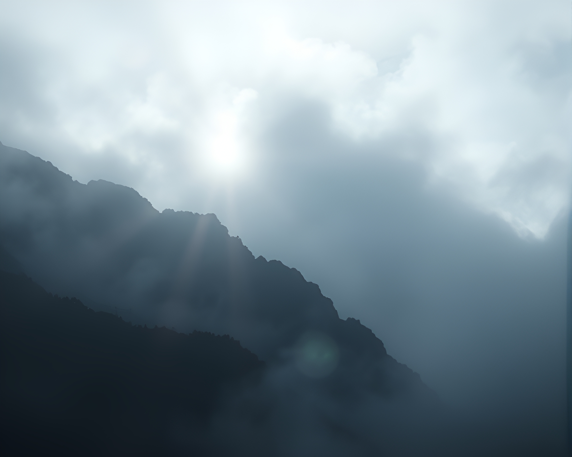 Mist-veiled Mountain Summit with Lens Flare Duochrome Glow – free AI stock image