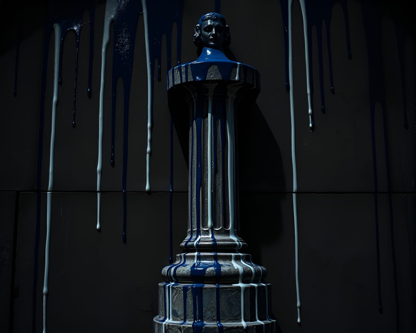 Graffiti drips create shadows on a majestic cobalt statue