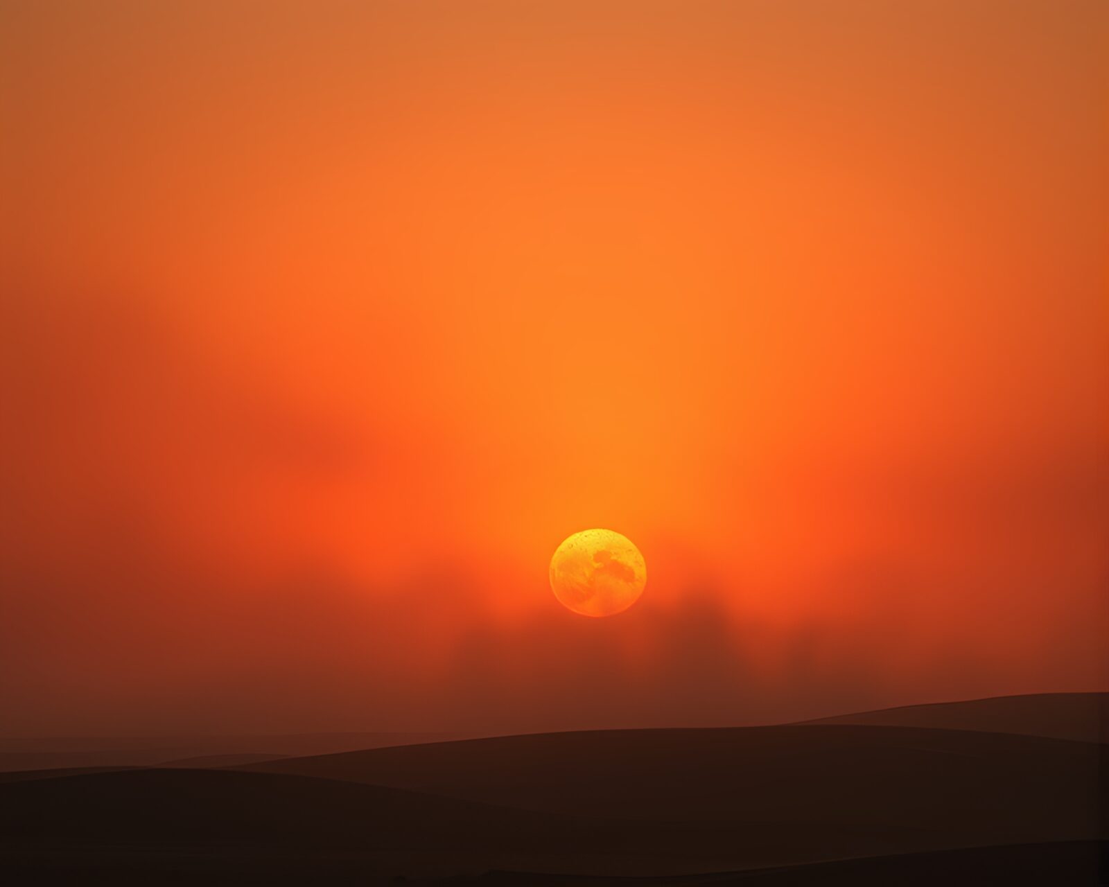 Vivid orange desert scene with swirling dust particles in motion