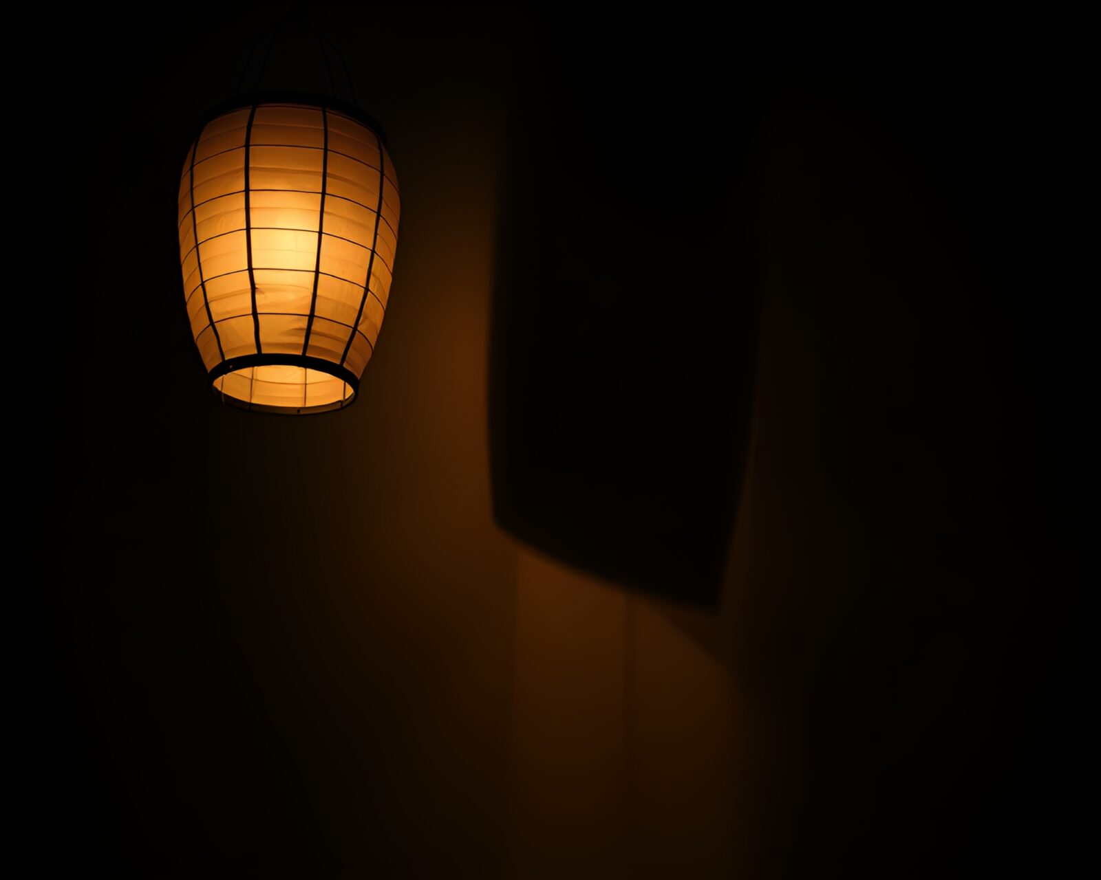 A stunning image of a glowing paper lantern amidst dramatic cloud formations