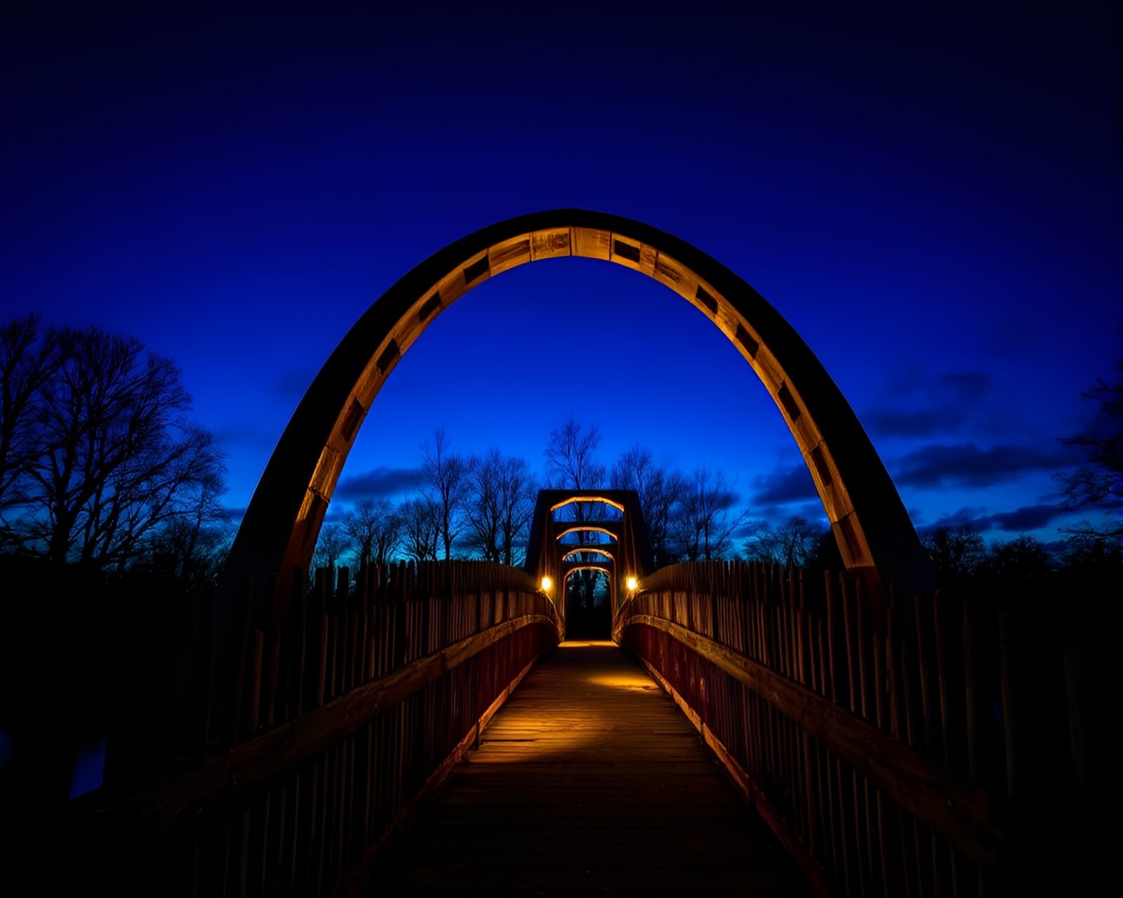 Majestic arch bridge with intense wood grain texture at dusk