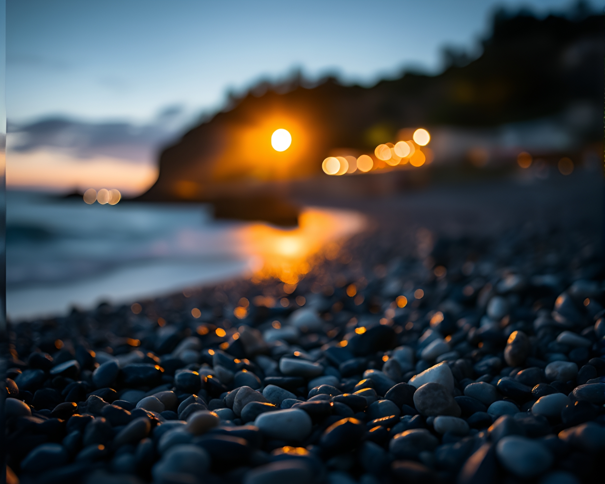 Torchlit Pebble Beach at Dusk with Foreground Interest – free AI stock image