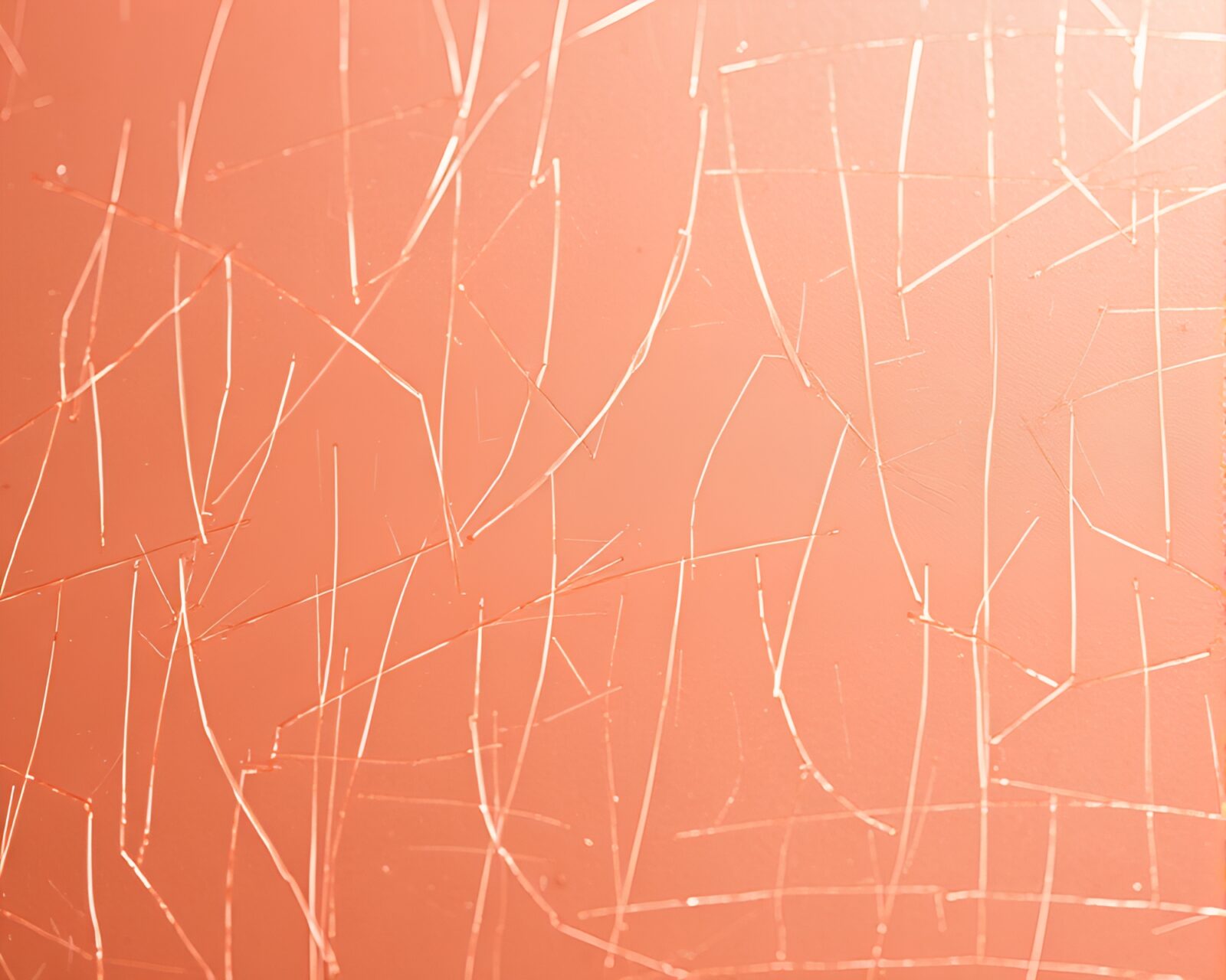 Moody rose gold lamp on scratched metallic background