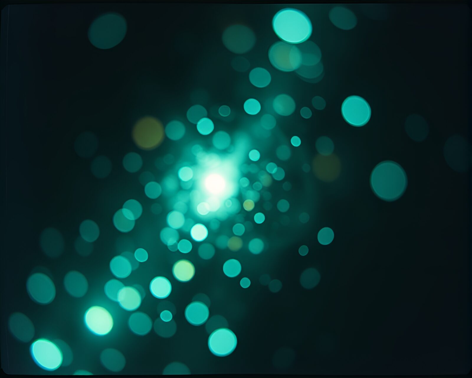Double exposure of glowing quantum computer portal surrounded by film sprocket holes and dust motes