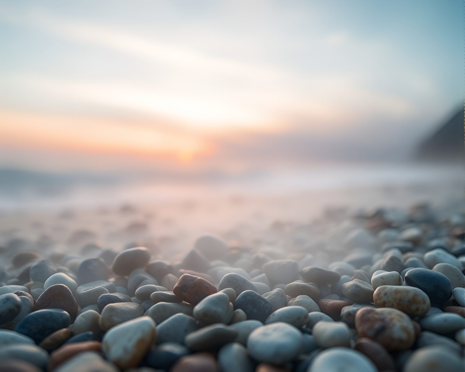 Abstract geometric shapes on misty beach at sunrise