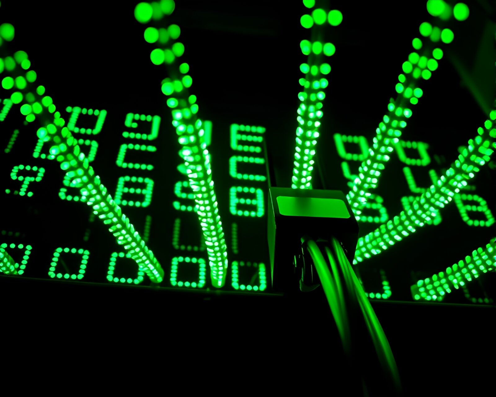 Low-angle shot of Morse code telegraph in vivid green light