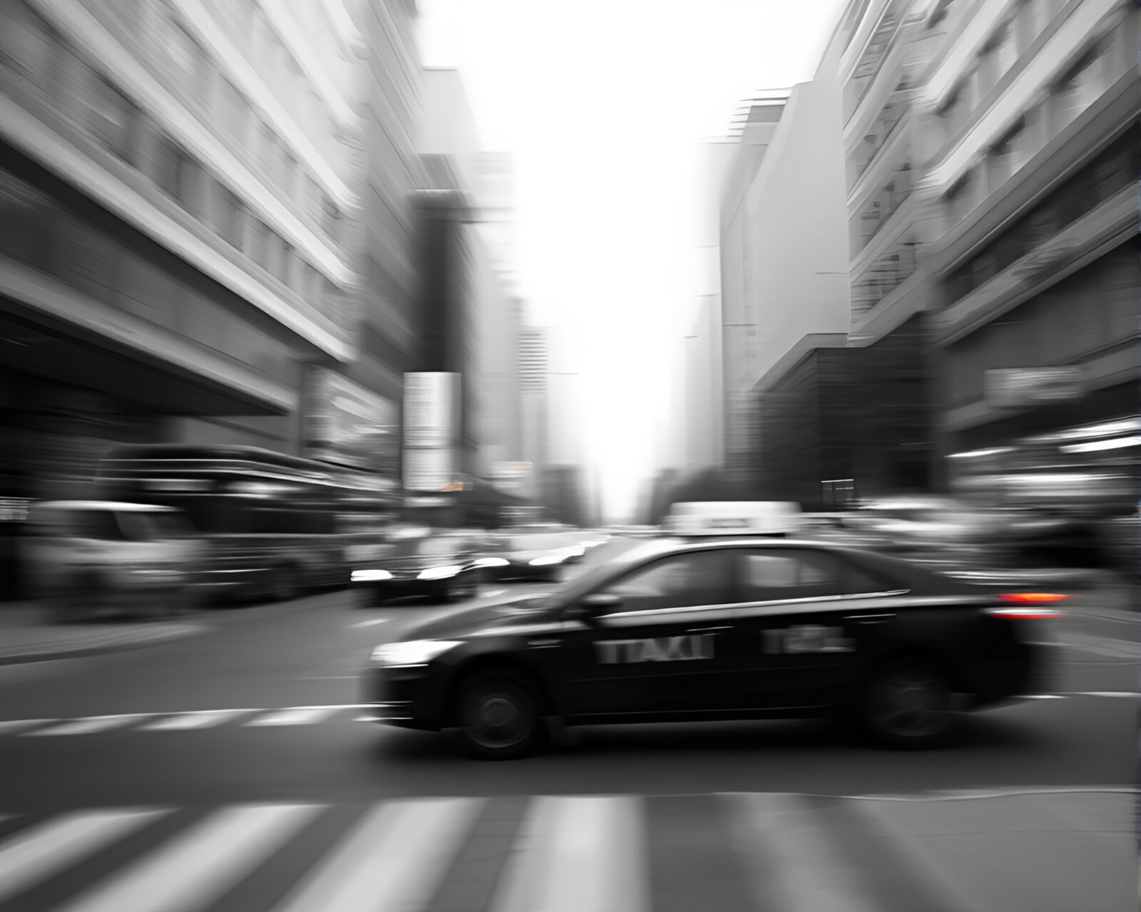 Blurry taxi speeding past ancient monochrome cave art