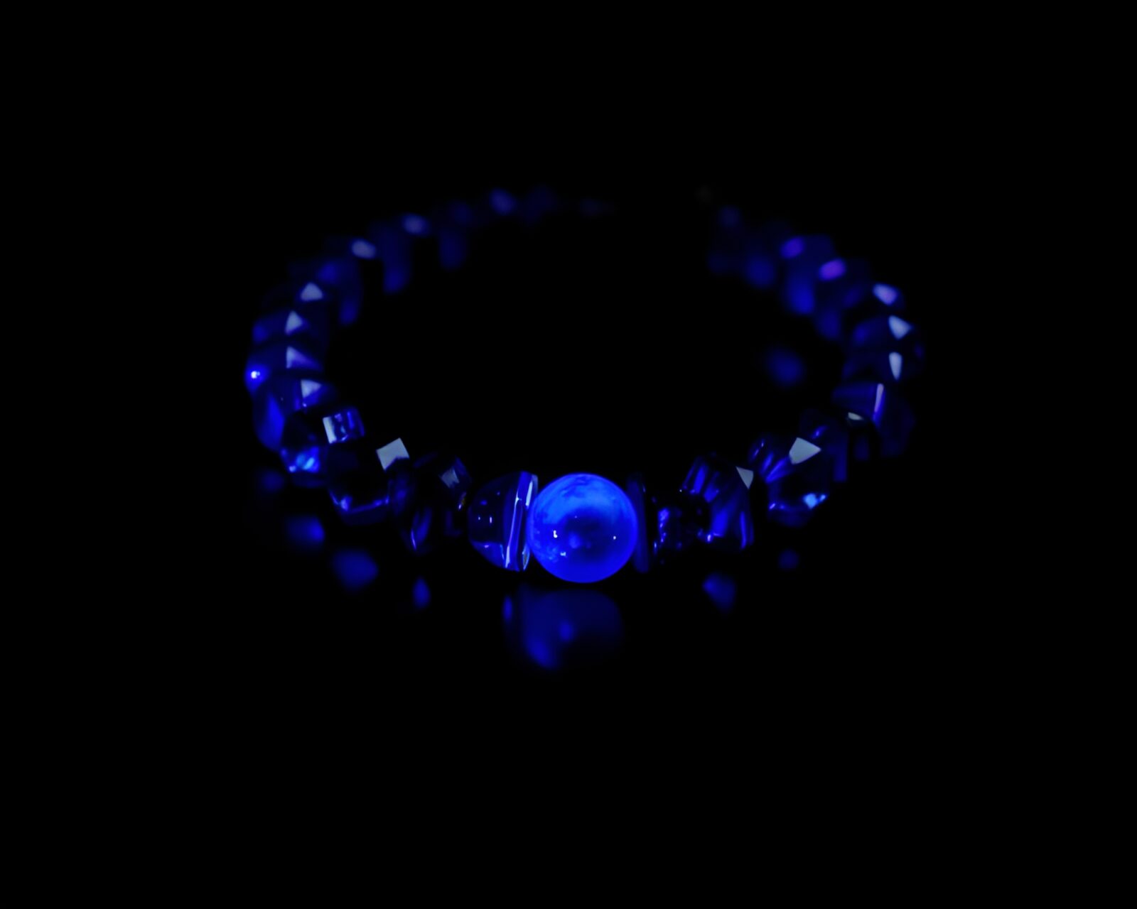 Mysterious ultraviolet bracelet positioned off-center in indigo light