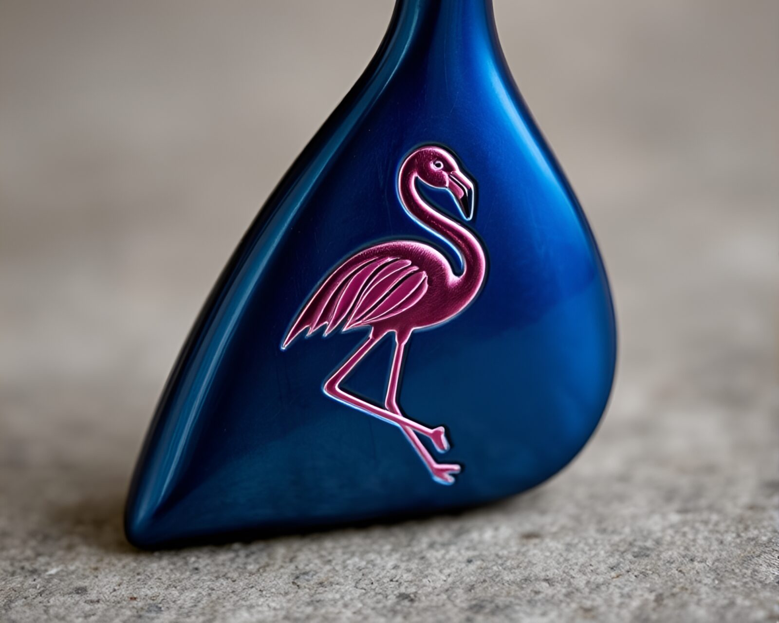 Metallic finish flamingo with detailed engravings on minimalist background.