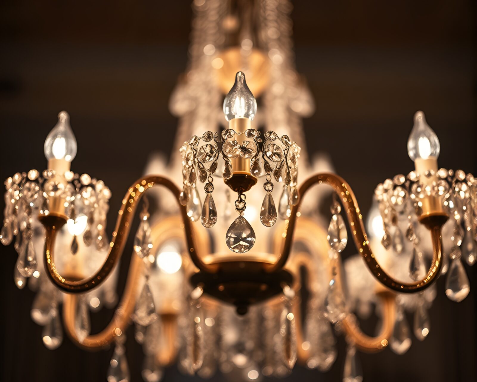 Selective focus on sparkling crystal chandelier in low light