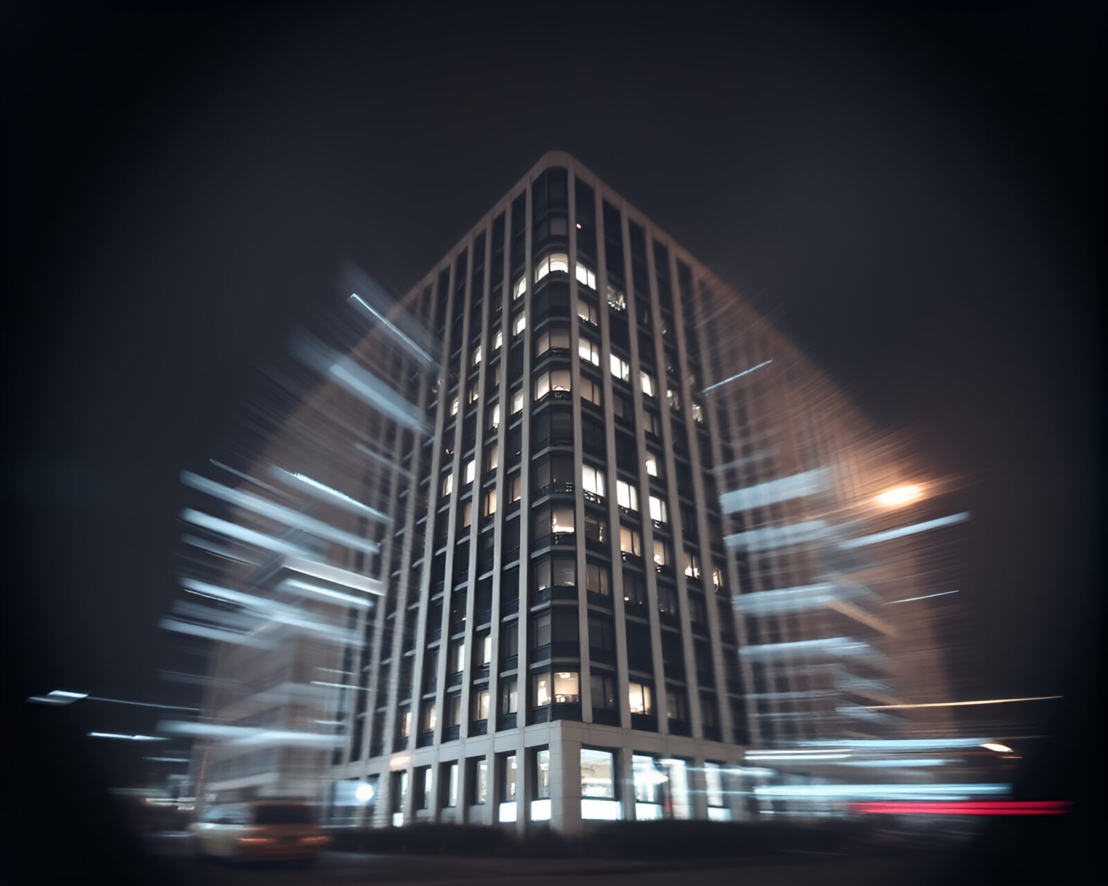 Two imposing Brutalist buildings merged in a lens vignette