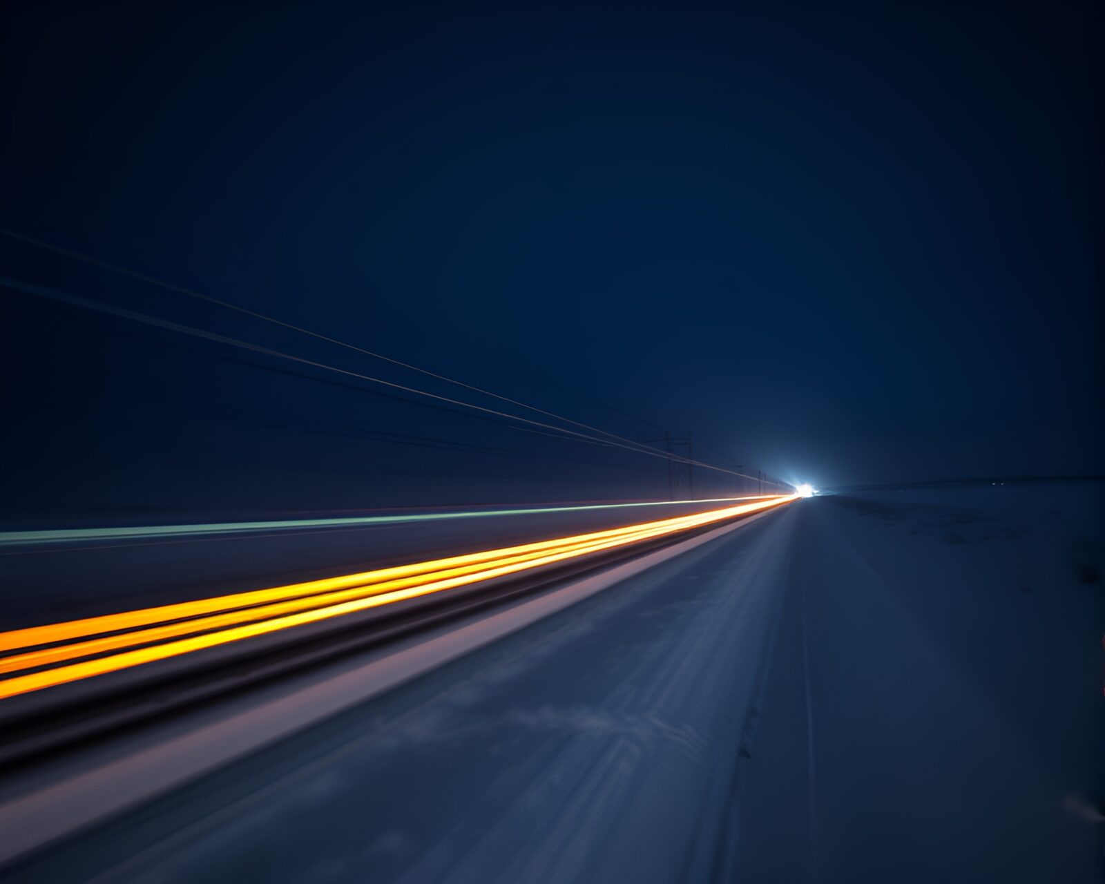 Tilt-shift photography of surreal train light trails in snow