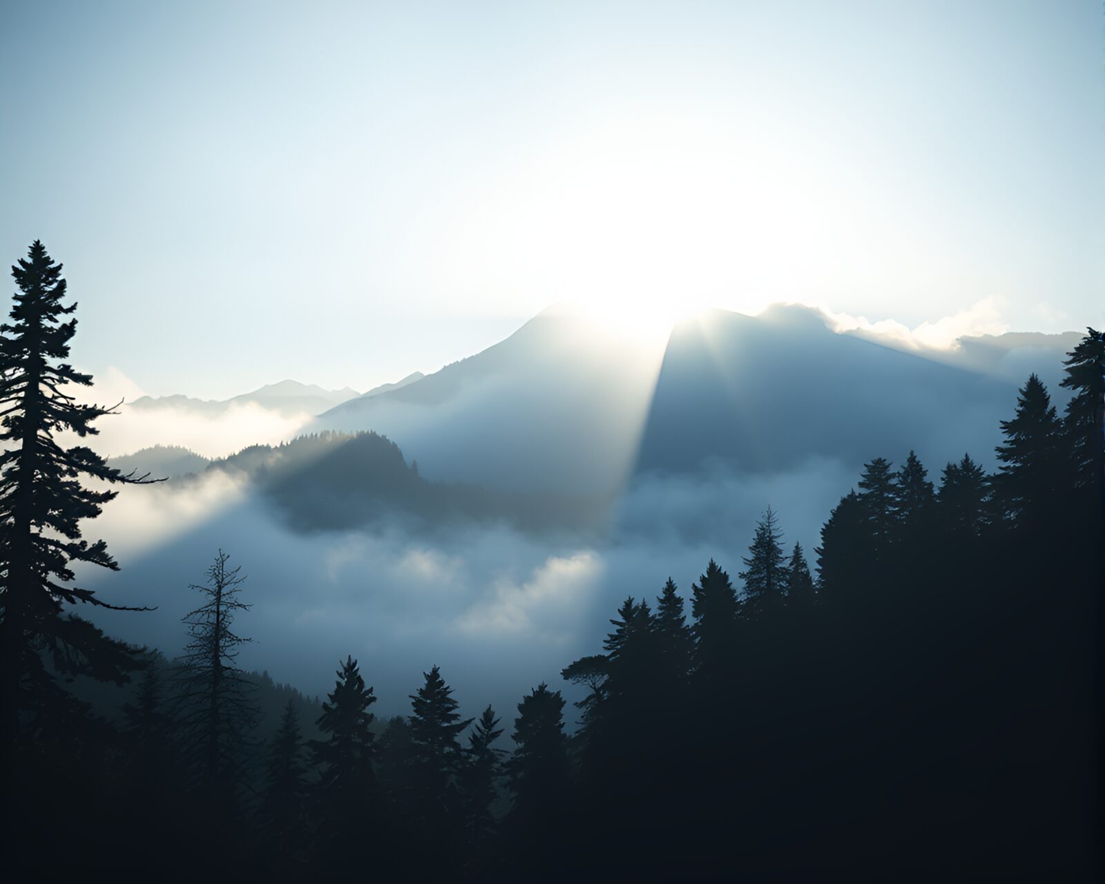Surreal worm's eye view of misty mountain with light leaks