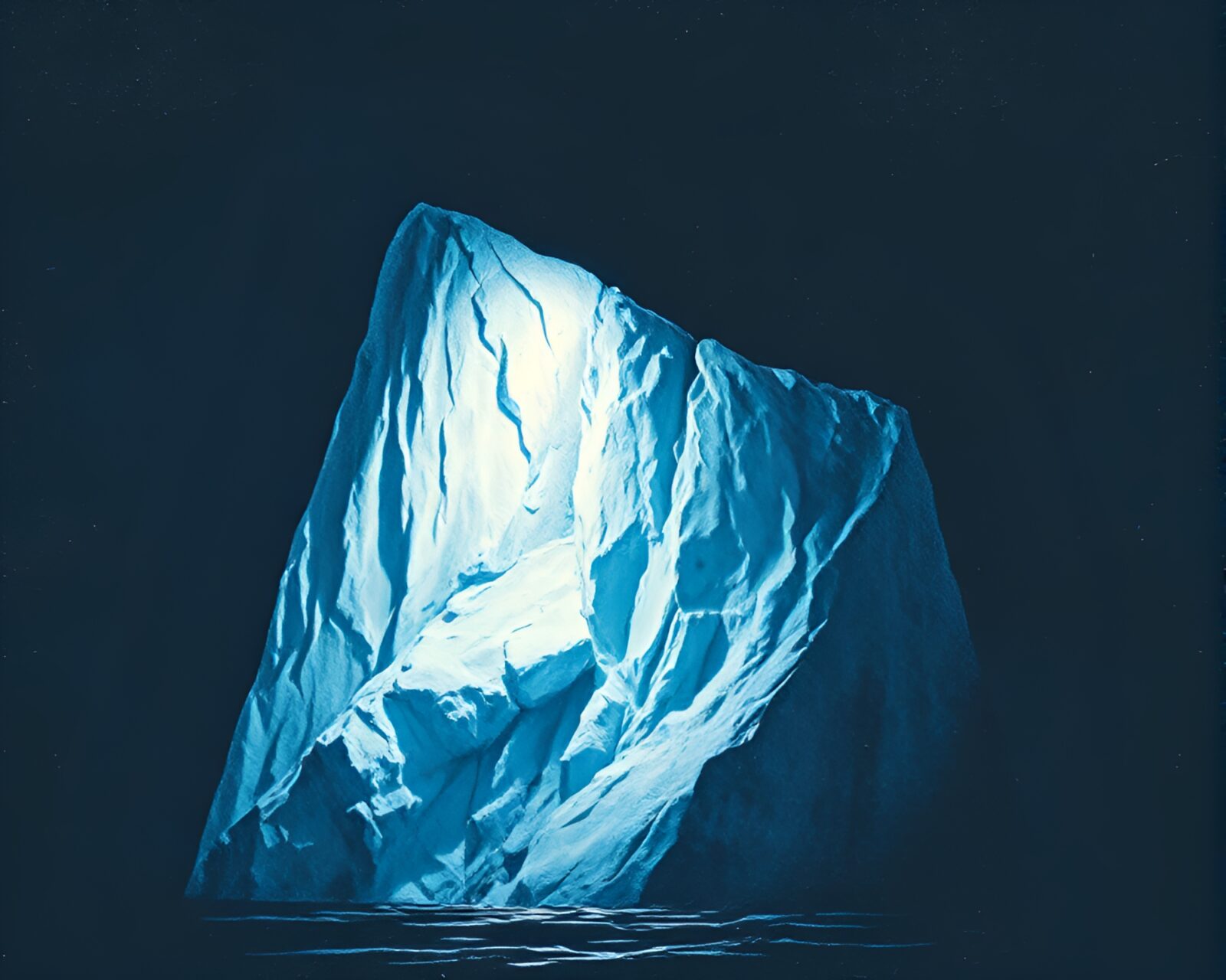 Surrealistically etched streetlamp-lit iceberg in Arctic landscape