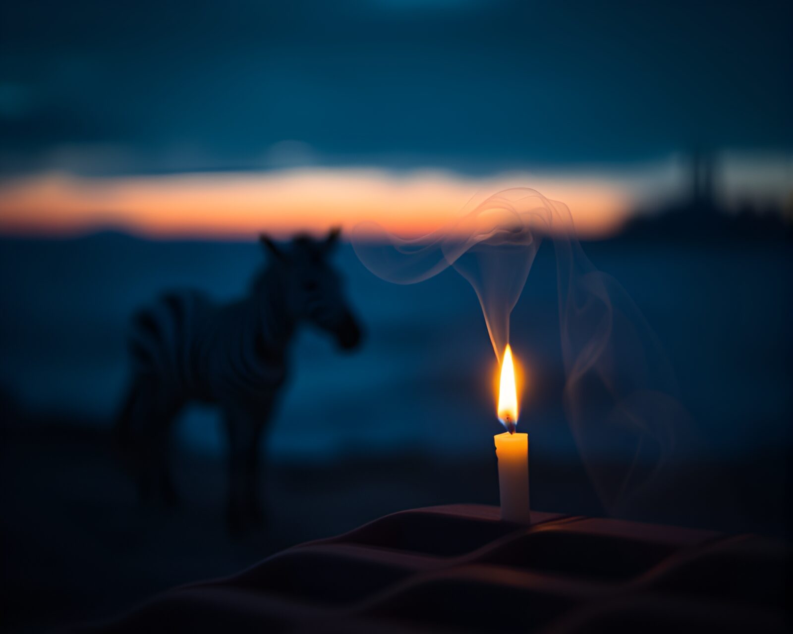 Abstract zebra silhouette engulfed in swirling candle smoke