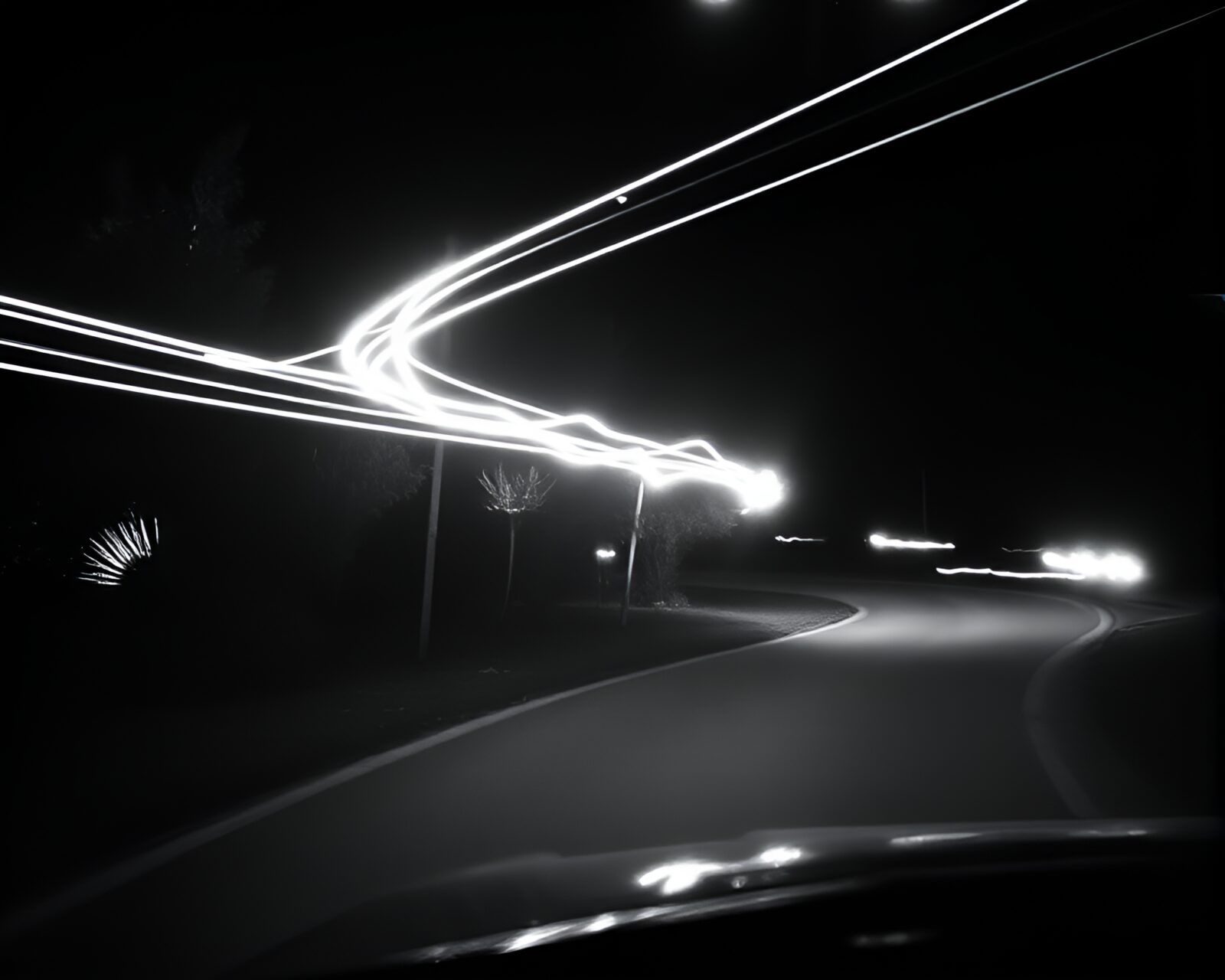 Monochrome green film noir scene with car light trails