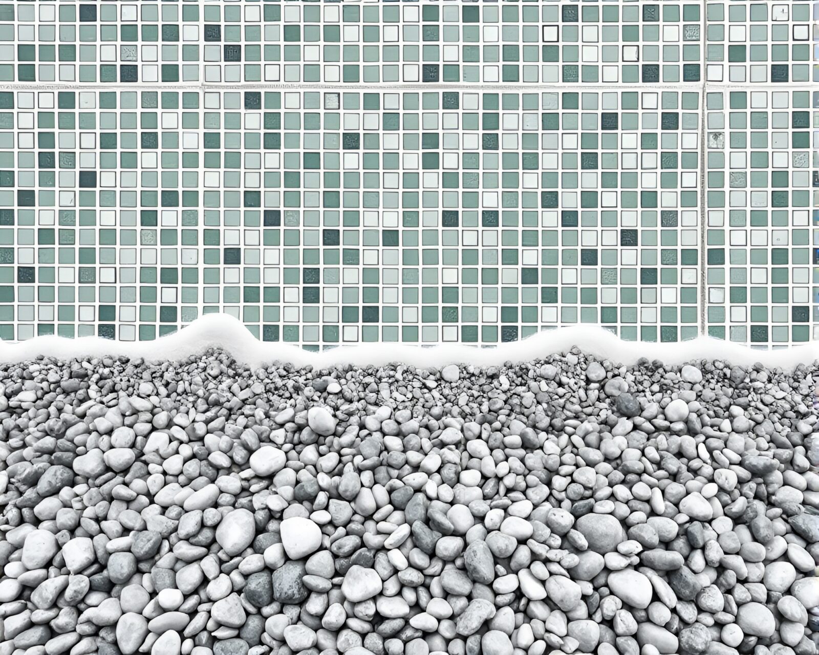 Tiled mosaic of monochrome green pebble beach design.