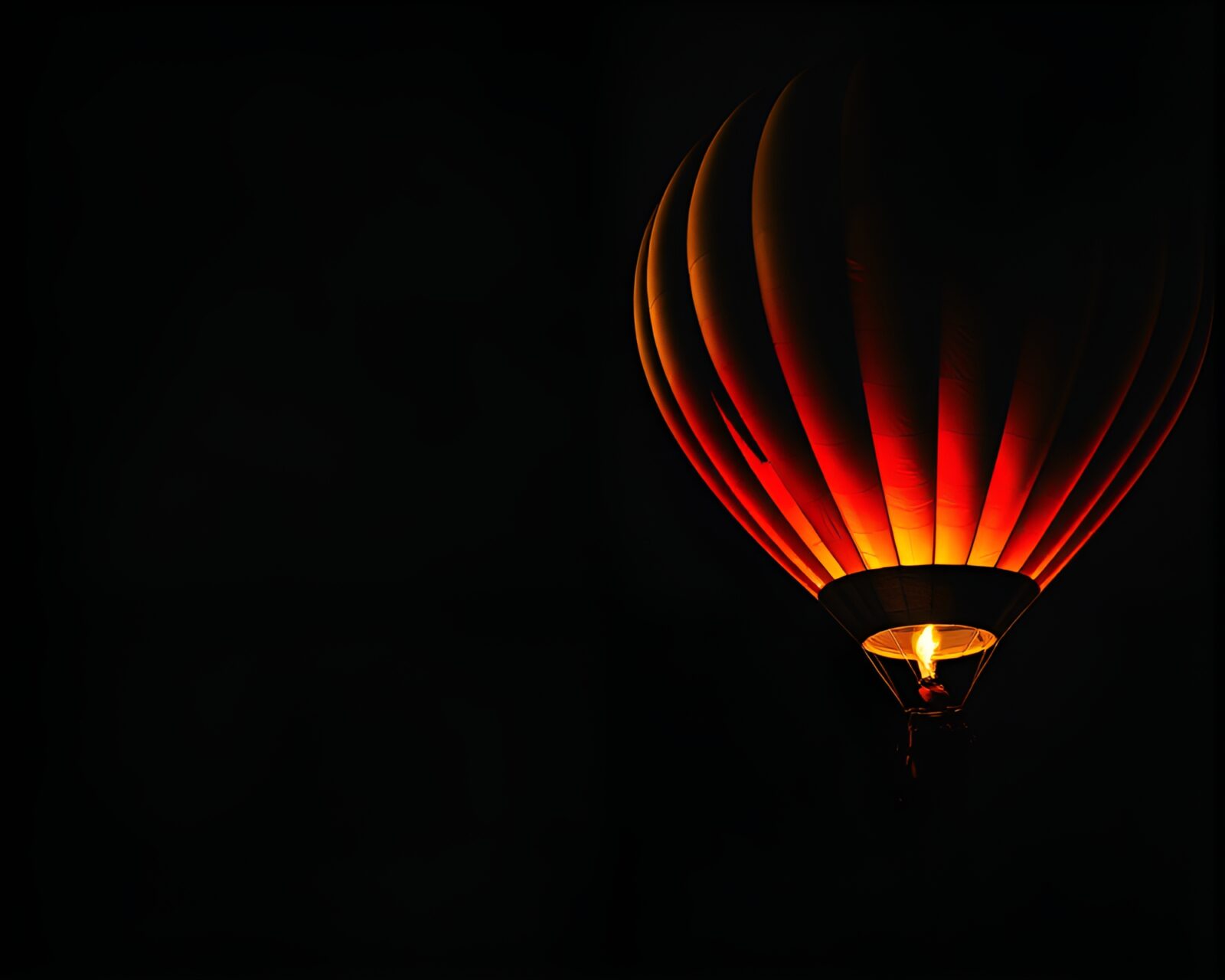 Dark, textured overlay with eerie hot air balloon and torchlight